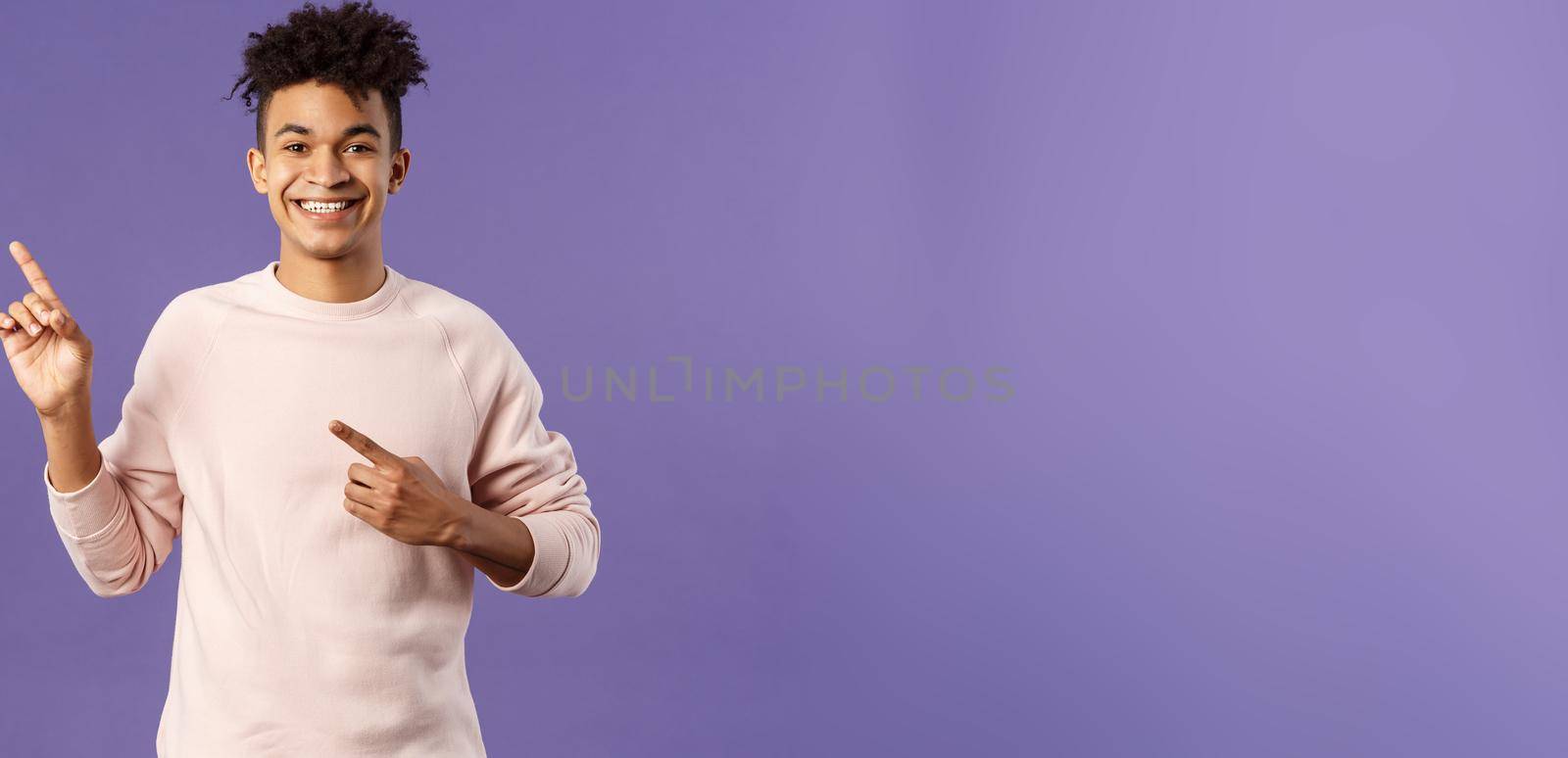 Portrait of cheerful, healthy smiling man pointing fingers upper left corner, recommending buy product, shop online, order delivery, advertisement and people concept, purple background by Benzoix