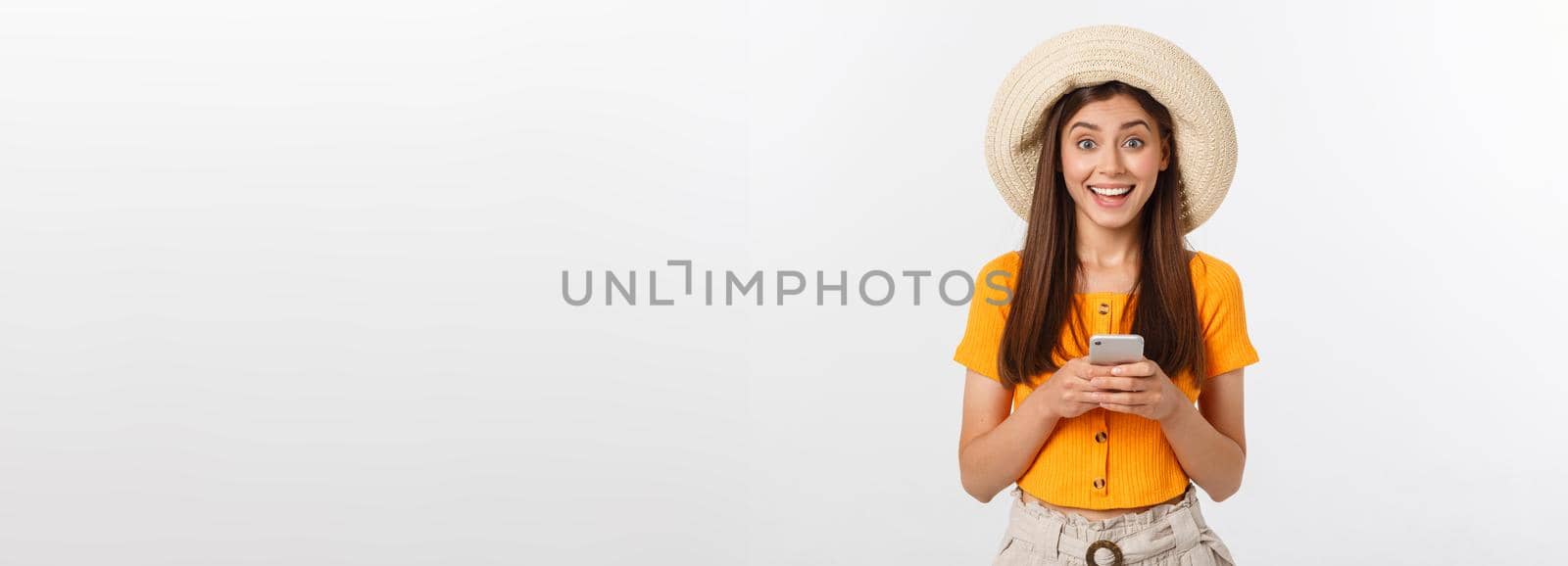 Happy young caucasian woman using smartphone standing isolated on white