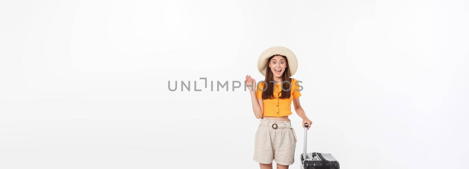 Woman tourist. Full length happy young woman standing with suitcase with exciting gesturing, isolated on white background