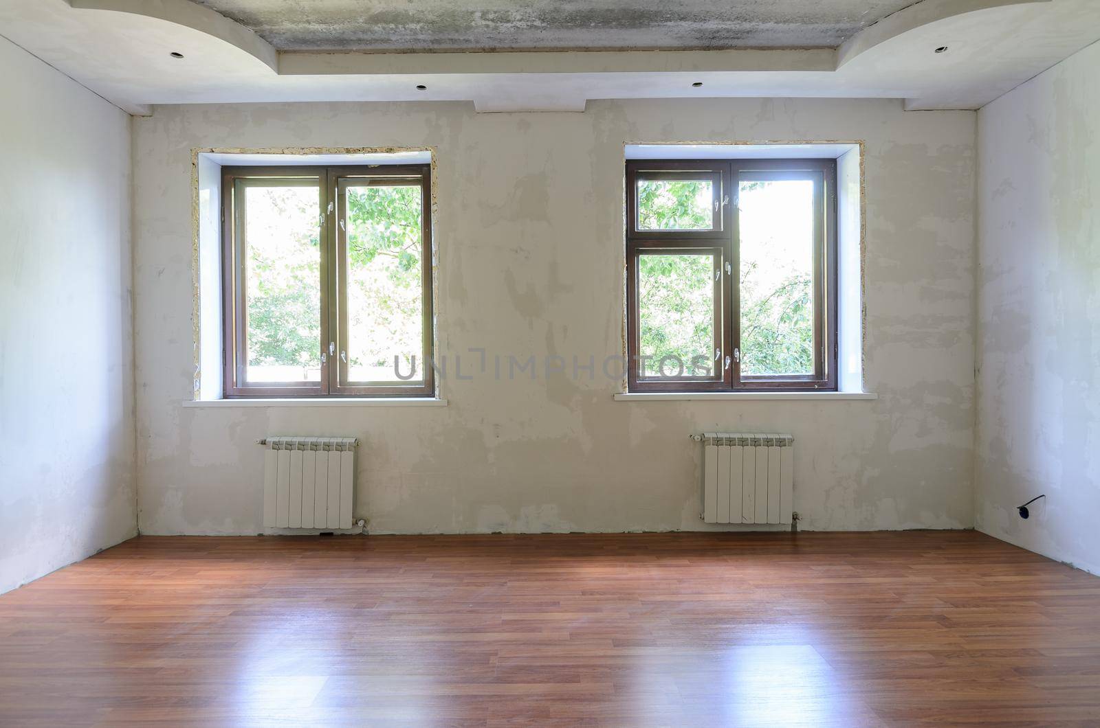 Interior of empty room during renovation, wall view with windows by Madhourse