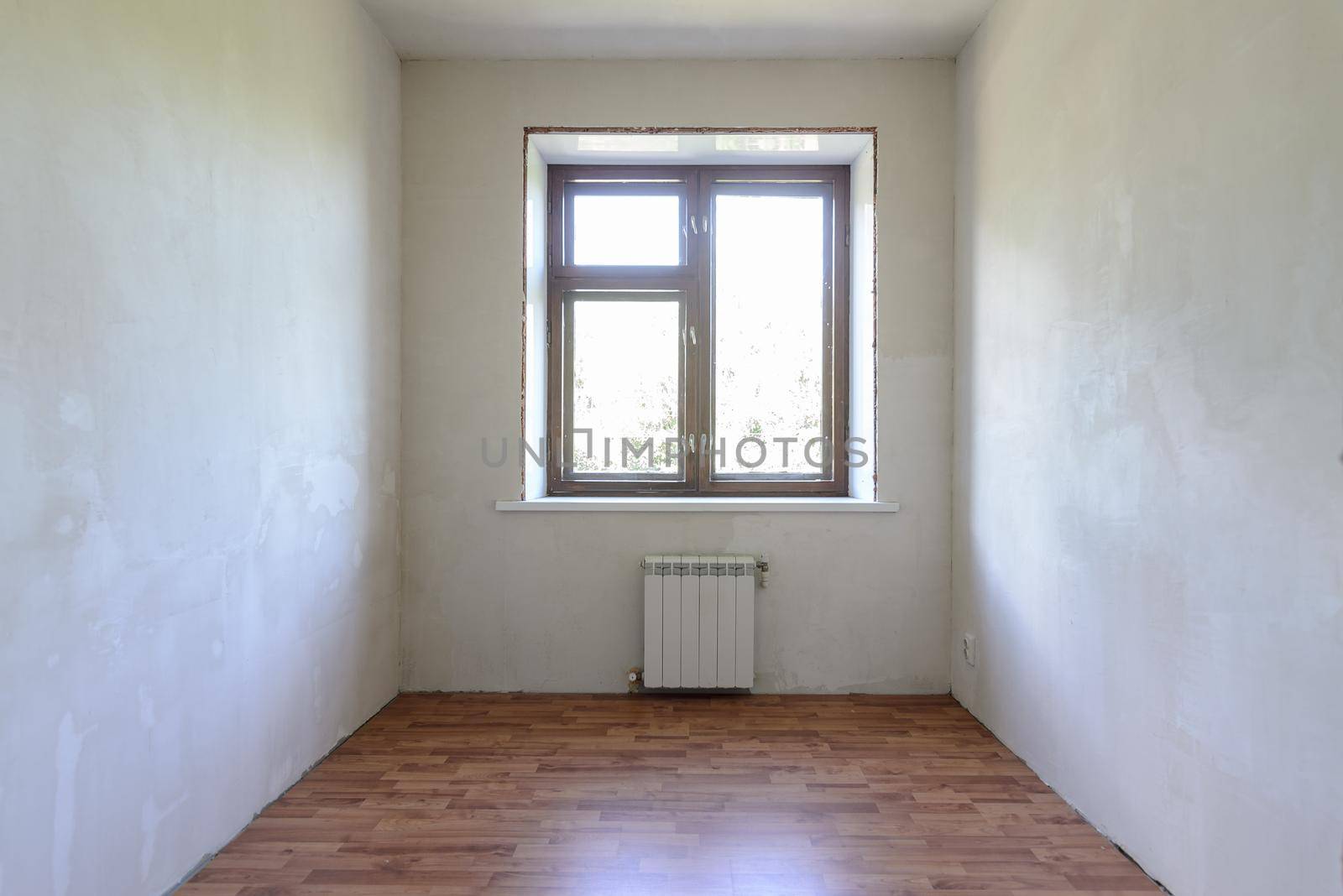 View of the window in a small room, the room has a laminate a