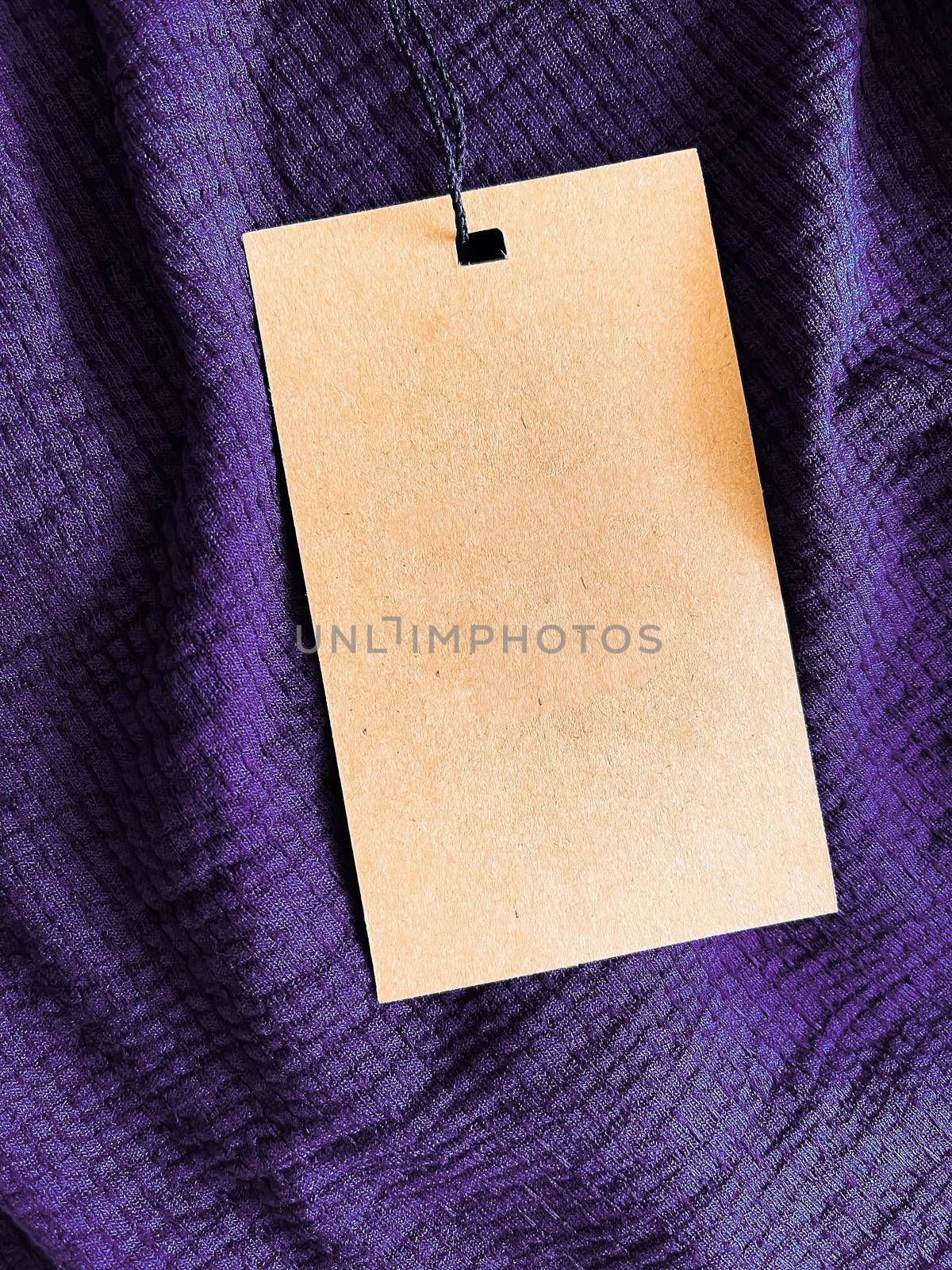 Blank fashion label tag, sale price card on luxury fabric background, shopping and retail by Anneleven