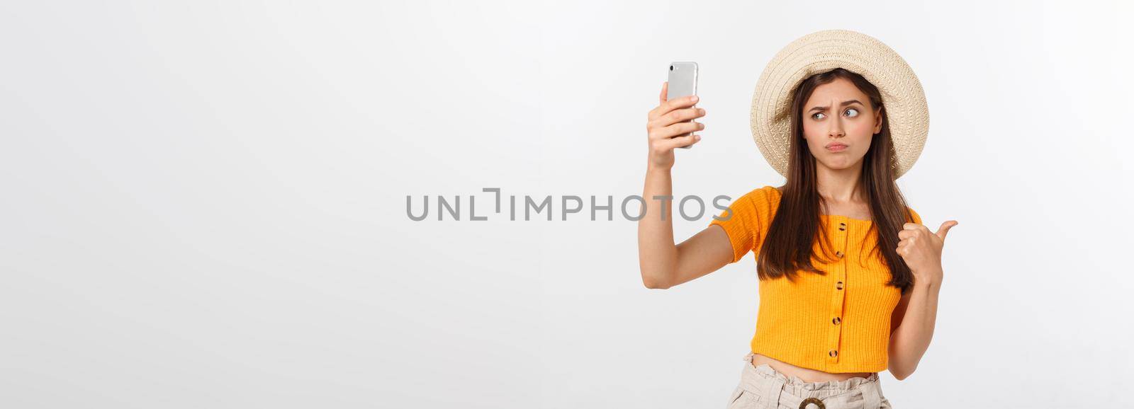 Young Caucasian woman enjoying the selfie with herself isolated on white background summer travel concept