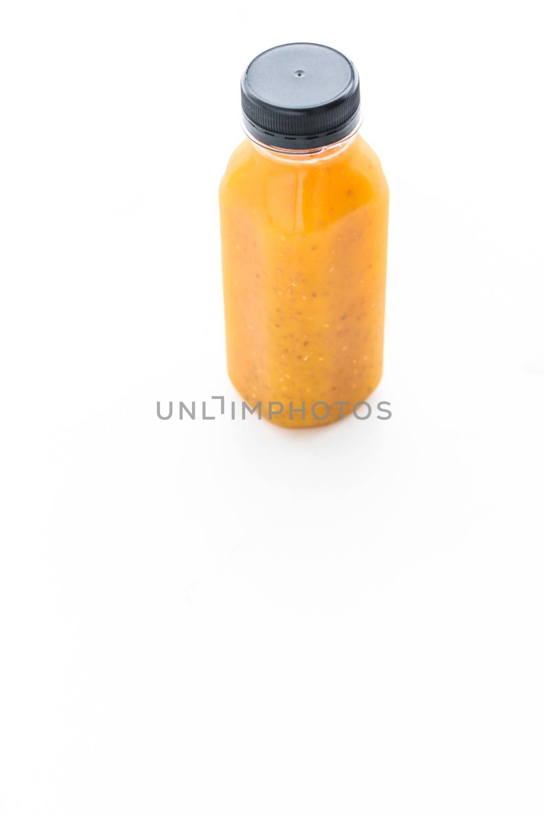 Healthy nutrition, organic drink and fasting cleanse concept - Detox fruit smoothie juice in a bottle, diet catering delivery. Isolated on white background