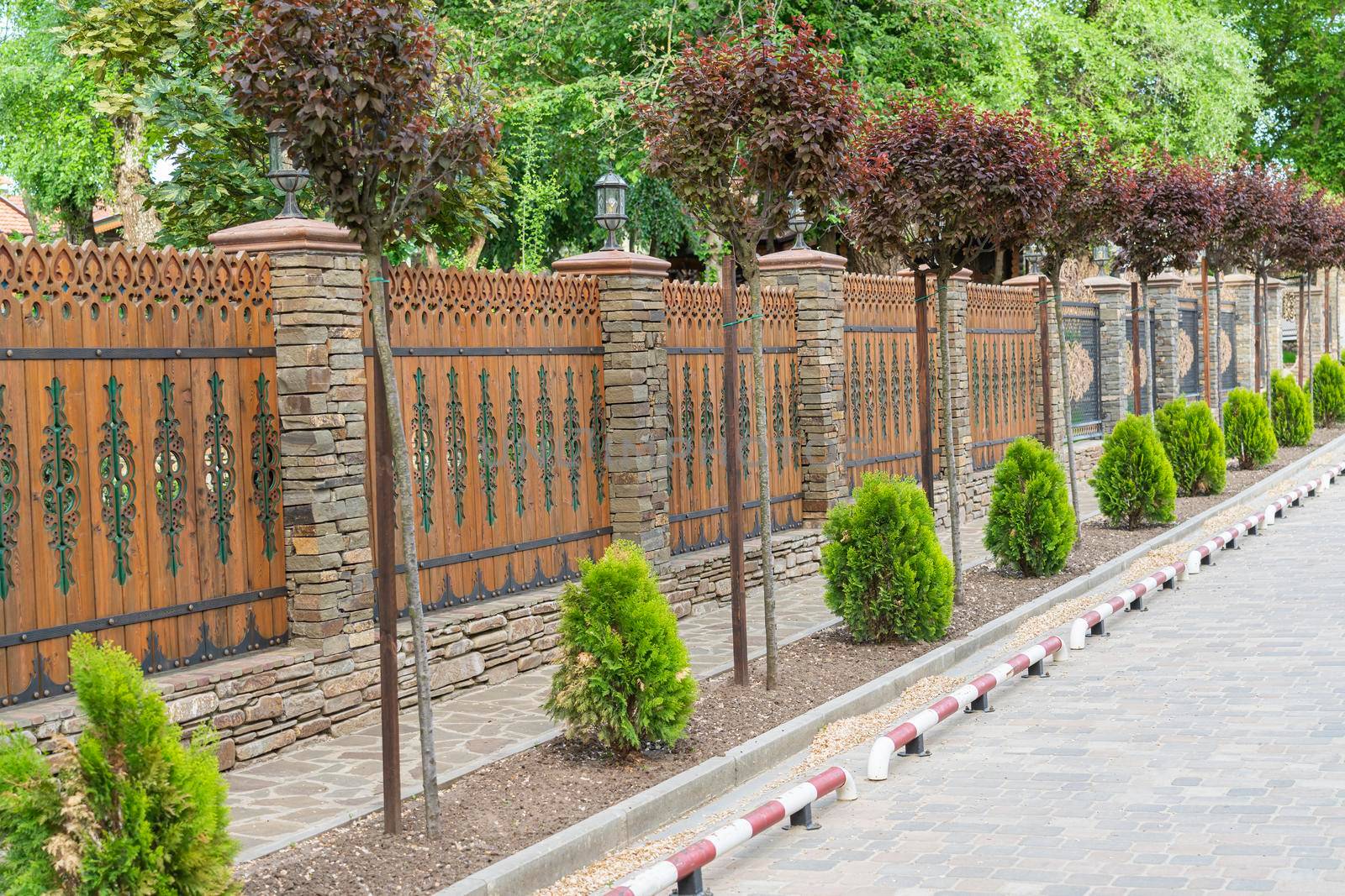 decorated sidewalk road by a beautiful fence. photo