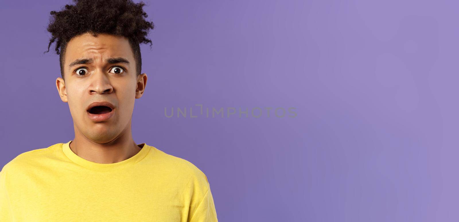 Close-up portrait of shocked, alarmed young man gasping, open mouth scared and frightened, staring camera concerned, facing troublesome shocking news, purple background by Benzoix