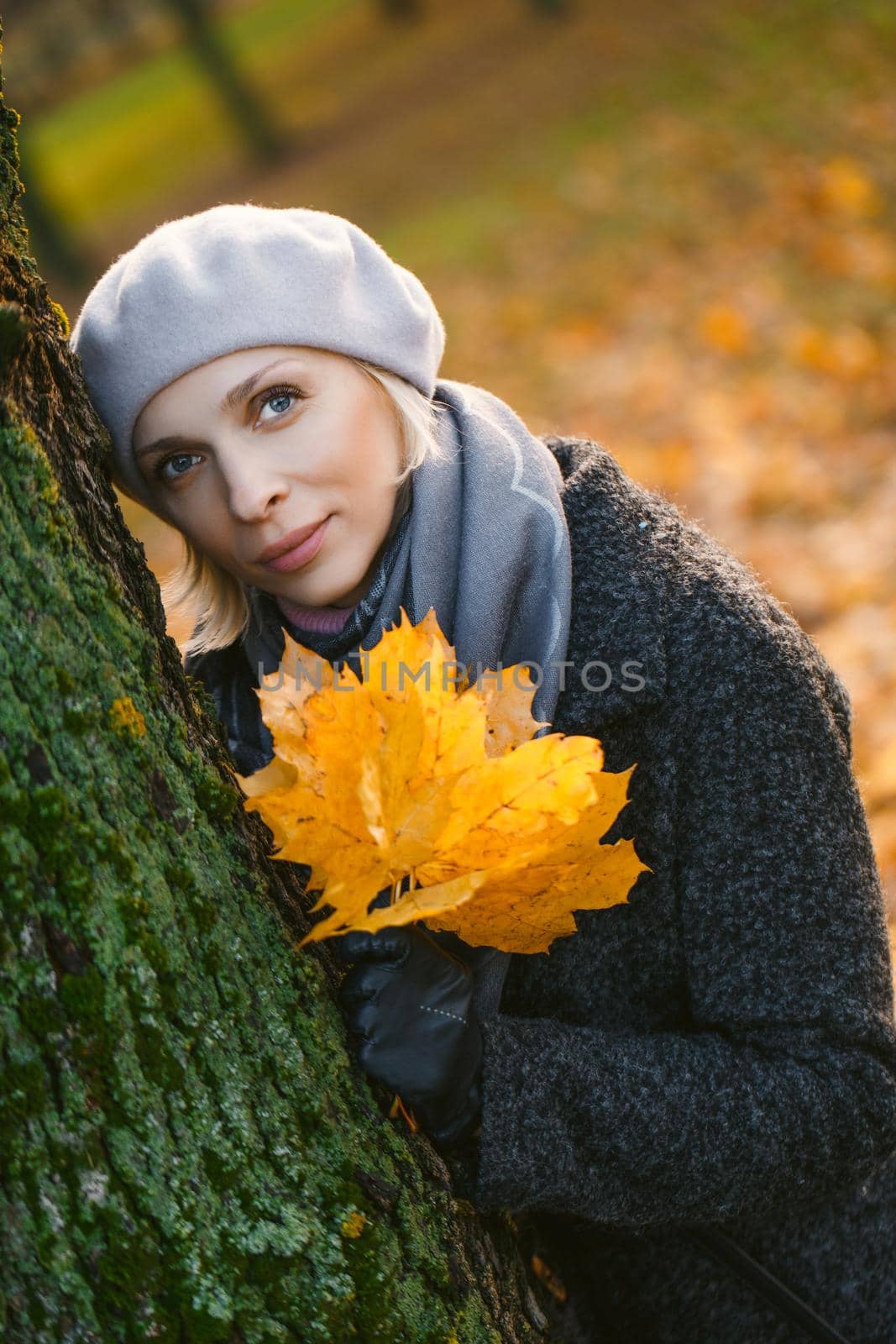 Style young blonde woman in autumn park