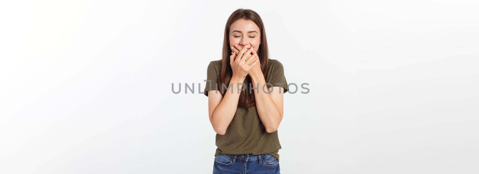 Happy woman laughing covering her mouth with a hands isolate over grey background. by Benzoix