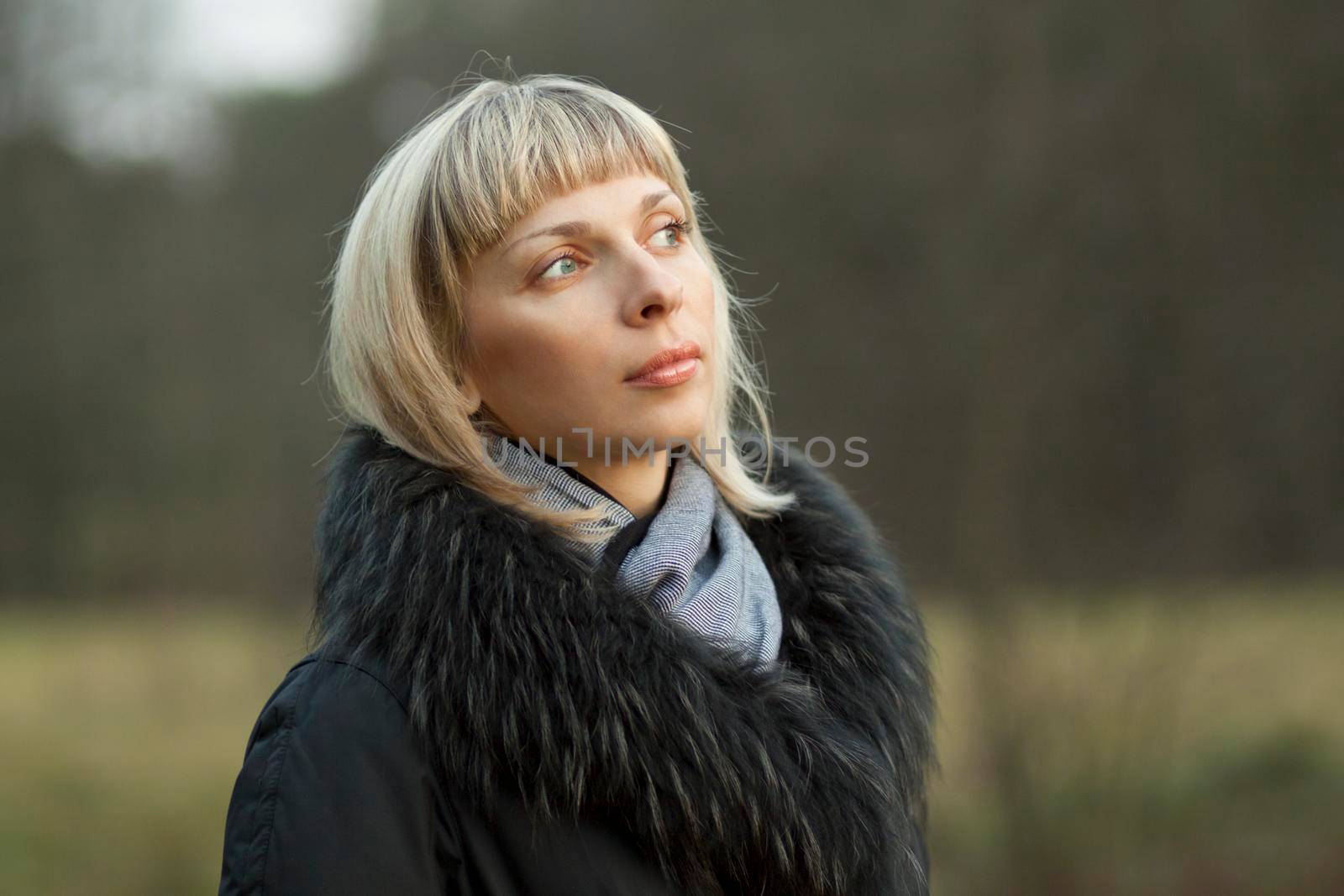 portrait of a woman in coat outdoors