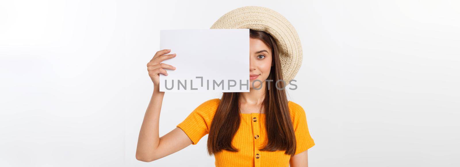 Happy business woman holding big white sign board. Gray wall back by Benzoix