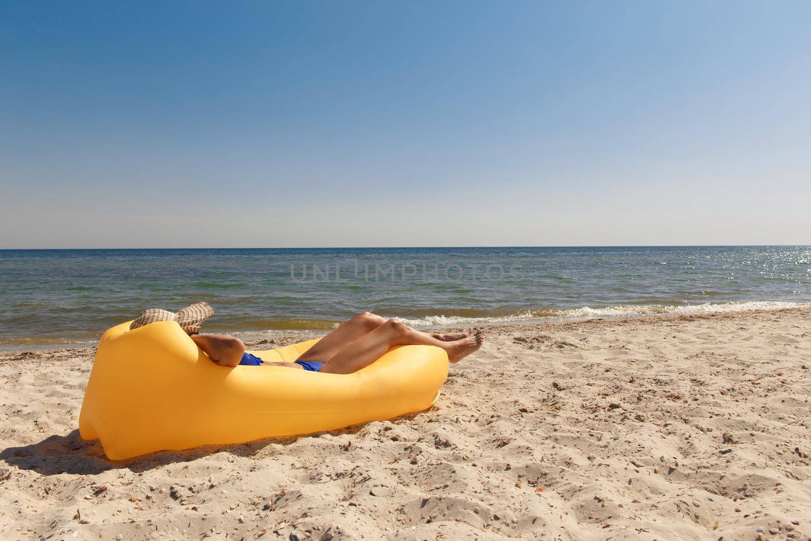 Girl relaxing on lamzac on the beach. Summer holiday idyllic on a tropical island.