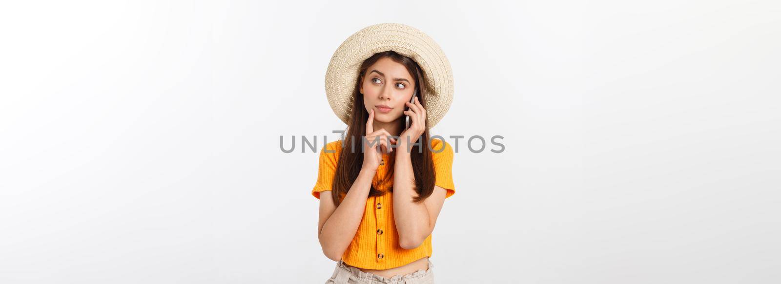 Serious young woman using smartphone and thinking isolated