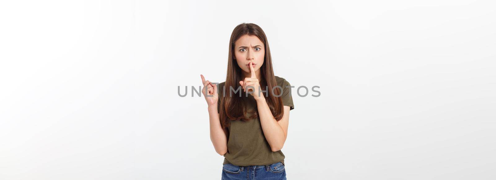 Beautiful woman showing finger over lips isolated on a white background. by Benzoix