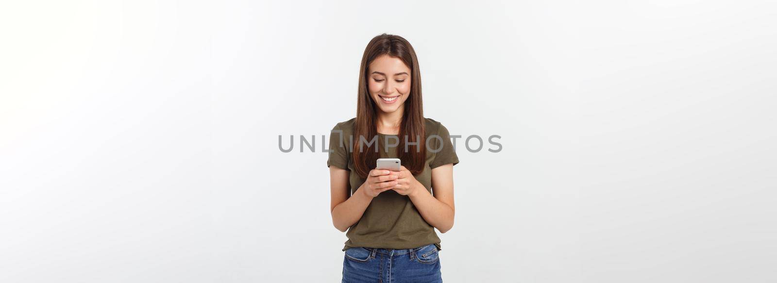 Laughing woman talking and texting on the phone isolated on a white background. by Benzoix