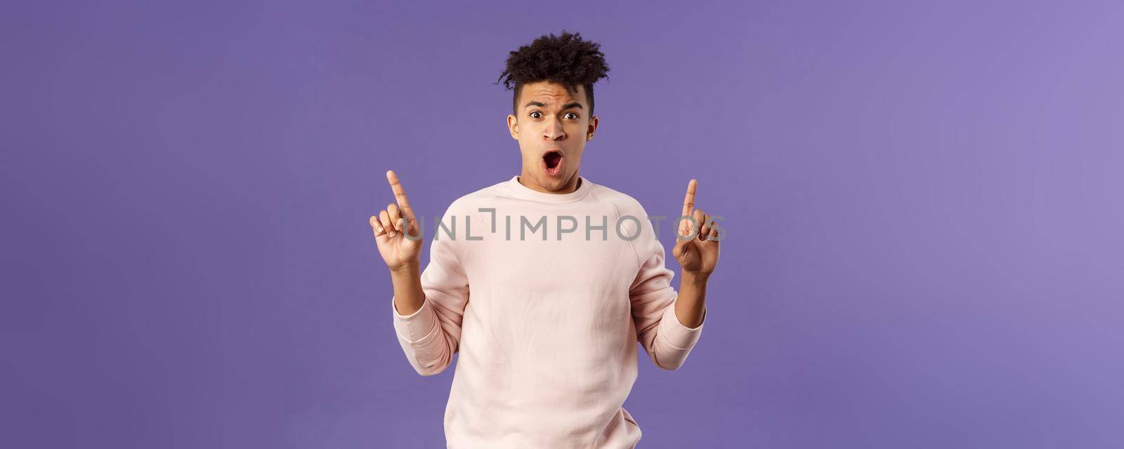 Portrait of shocked, speechless young hispanic man with dreads reacting to overwhelming shook news, gasping, drop jaw and staring concerned as pointing up at something astounding by Benzoix