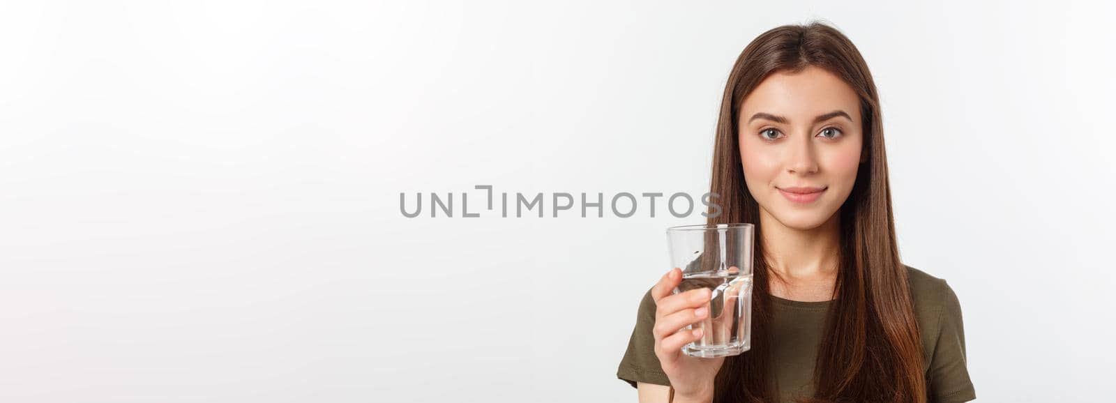 portrait of attractive caucasian smiling woman isolated on white studio shot drinking water. by Benzoix