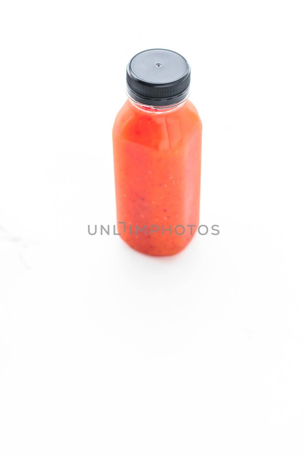 Detox red fruit smoothie juice in a bottle, diet catering delivery. Isolated on white background by Anneleven