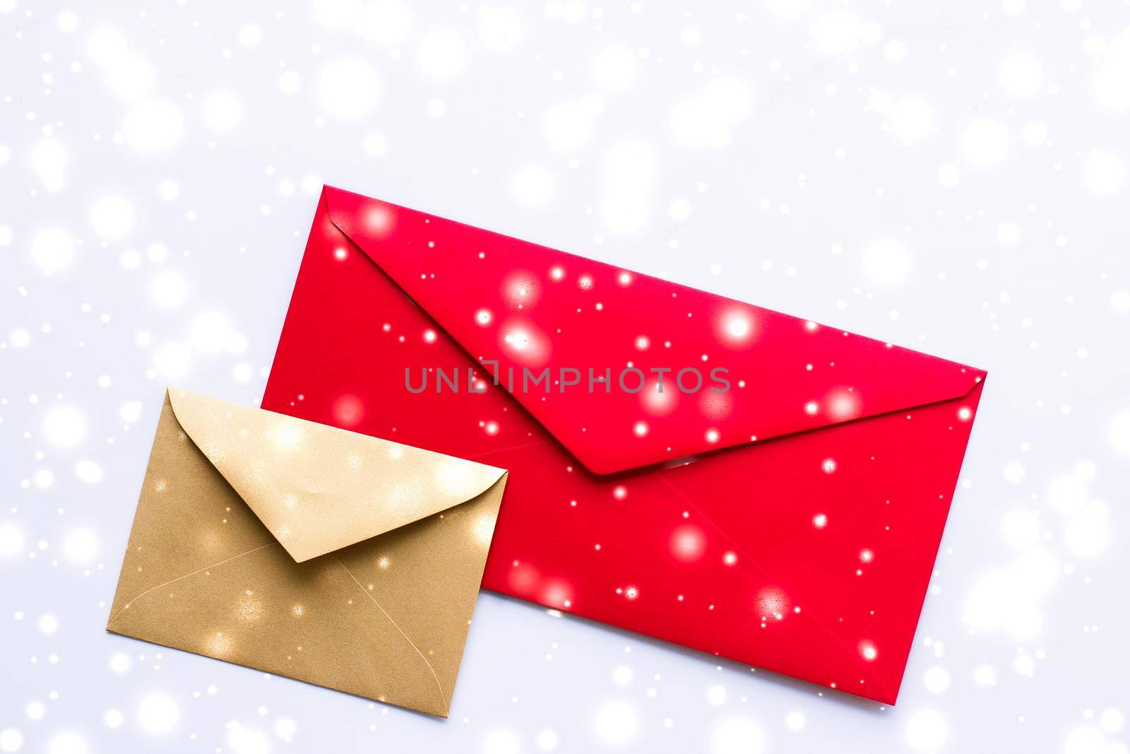 Greetings, postal service and online newsletter concept - Winter holiday blank paper envelopes on marble with shiny snow flatlay background, love letter or Christmas mail card design