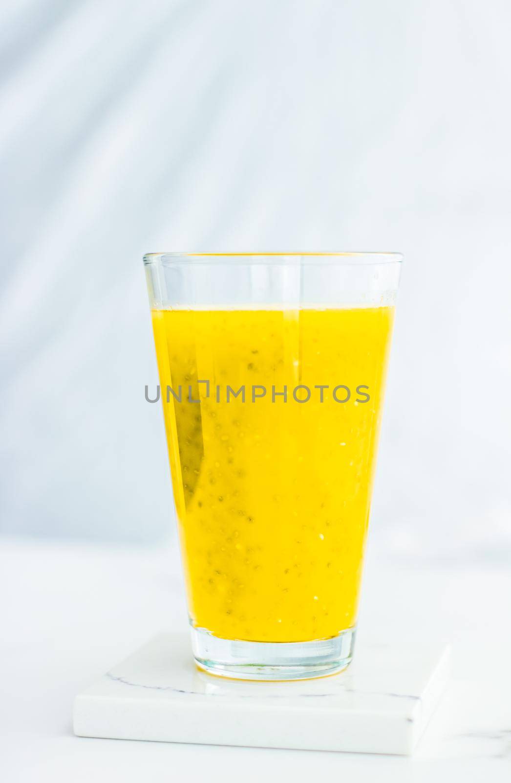 Healthy nutrition, organic drink and fasting cleanse concept - Glass of yellow fruit smoothie juice with chia seeds for diet detox, perfect breakfast recipe