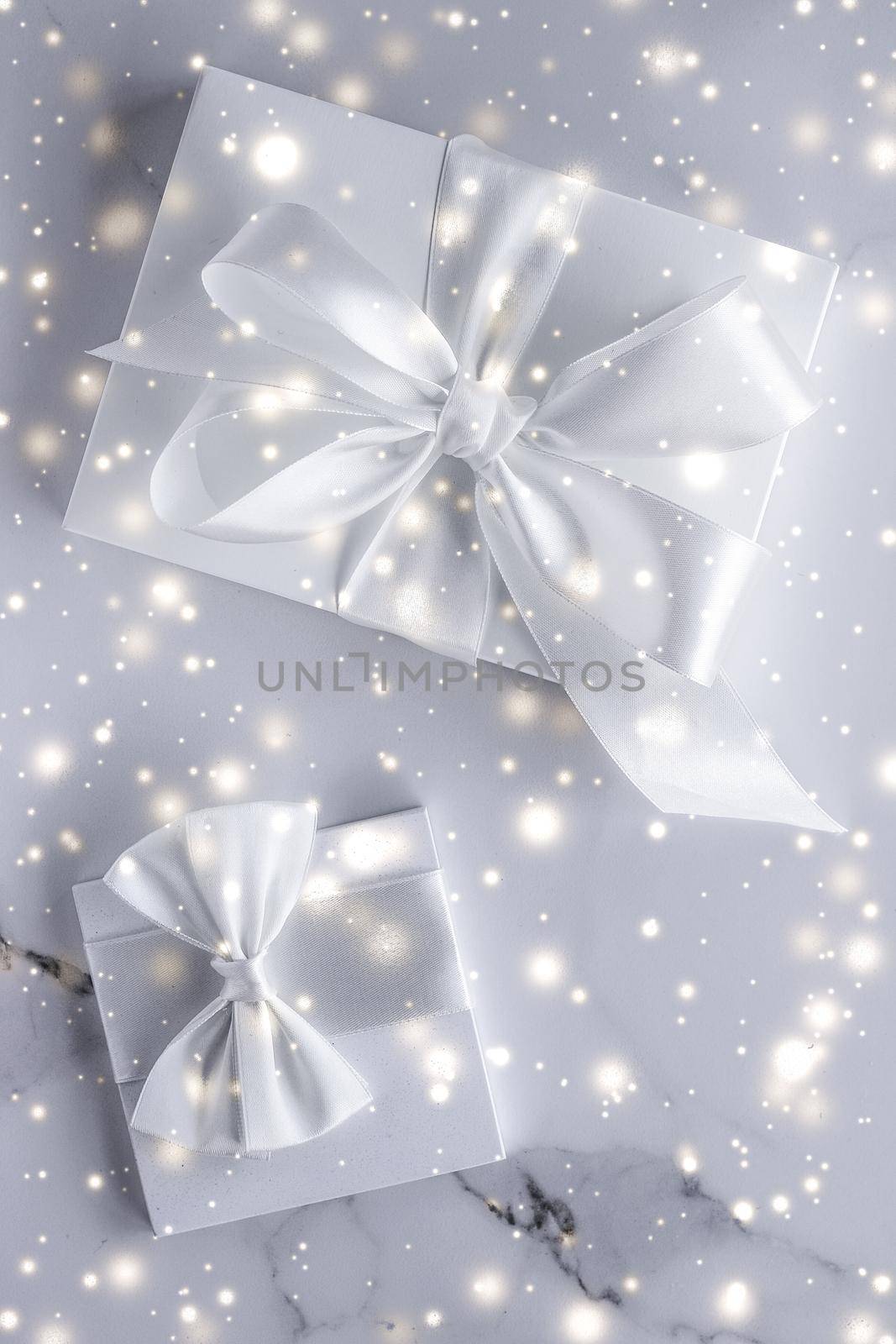 Luxury holiday gifts with white silk bow and ribbons on marble background, Christmas time surprise by Anneleven