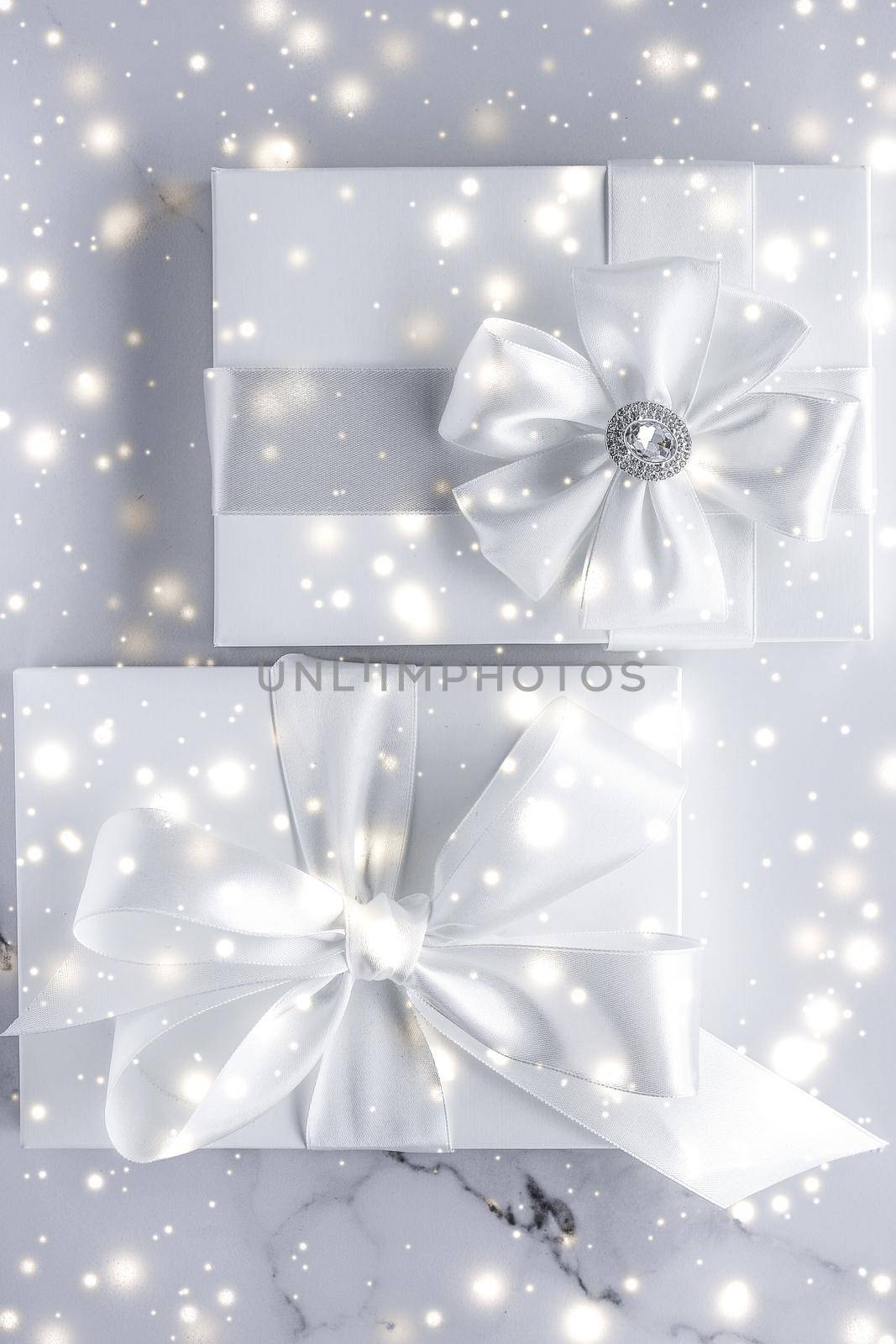 Luxury holiday gifts with white silk bow and ribbons on marble background, Christmas time surprise by Anneleven