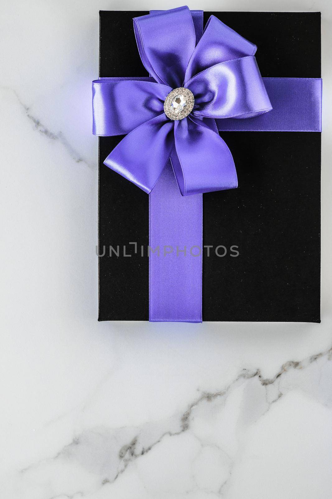 Wedding present, shop sale promotion and anniversary celebration concept - Luxury holiday gifts with lavender silk ribbon and bow on marble background