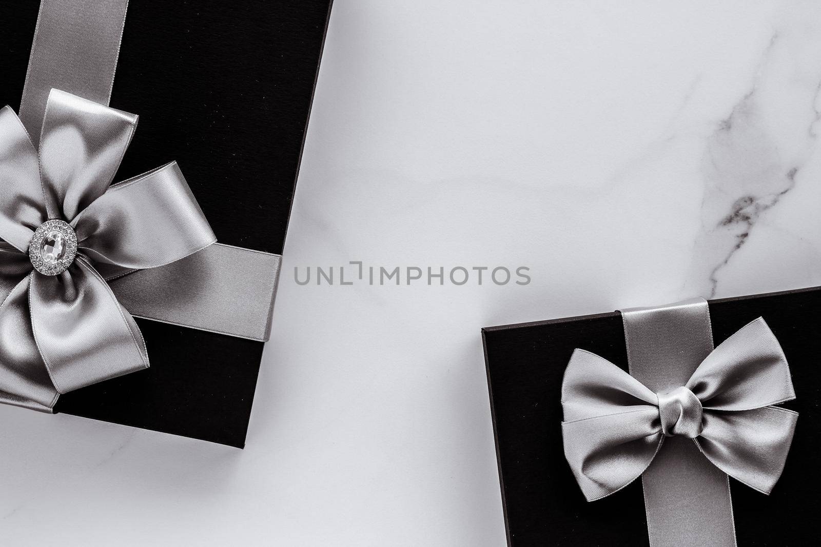 Present for him, shop sale promotion and anniversary celebration concept - Luxury holiday gifts with silver silk ribbon and bow on marble background