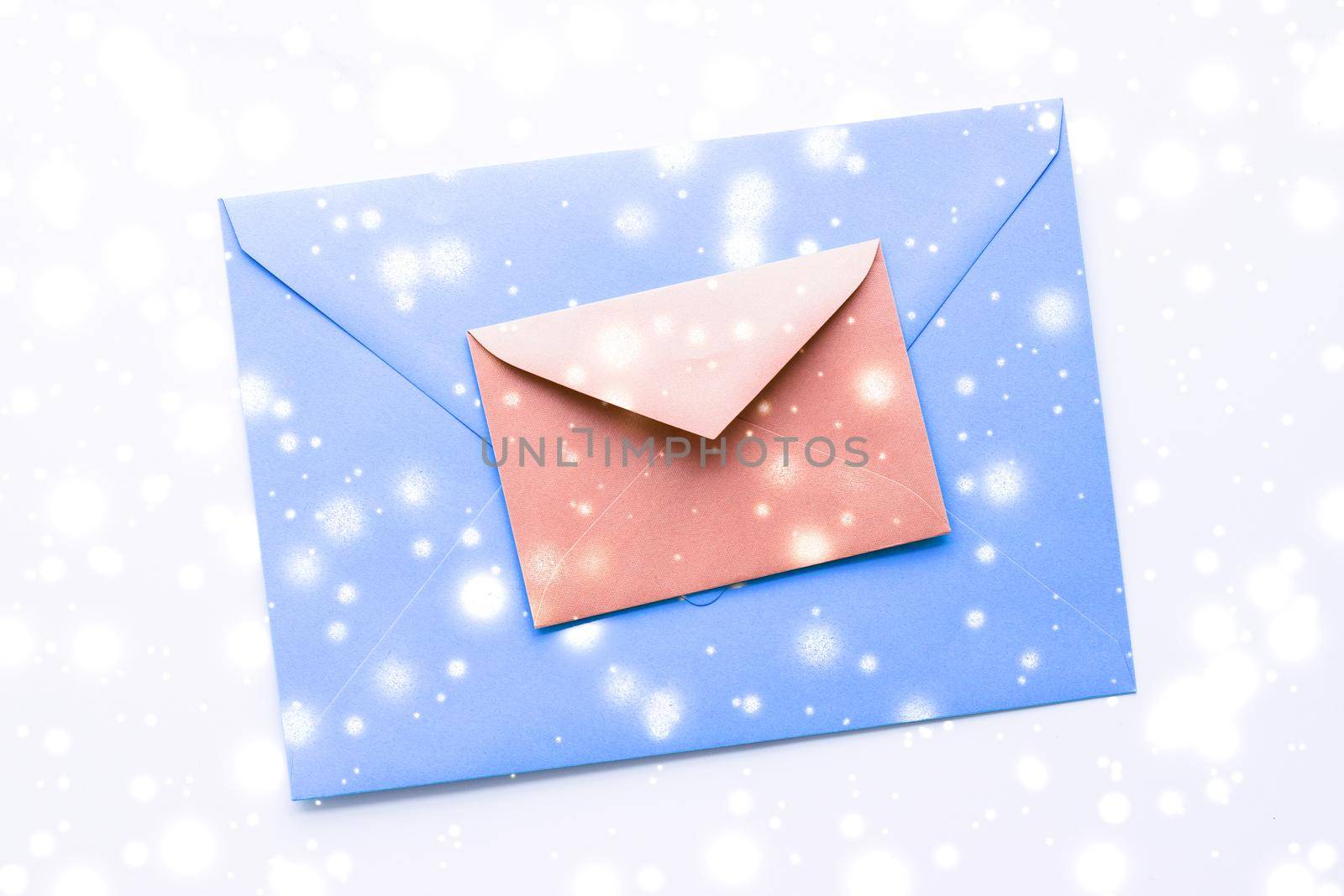 Greetings, postal service and online newsletter concept - Winter holiday blank paper envelopes on marble with shiny snow flatlay background, love letter or Christmas mail card design