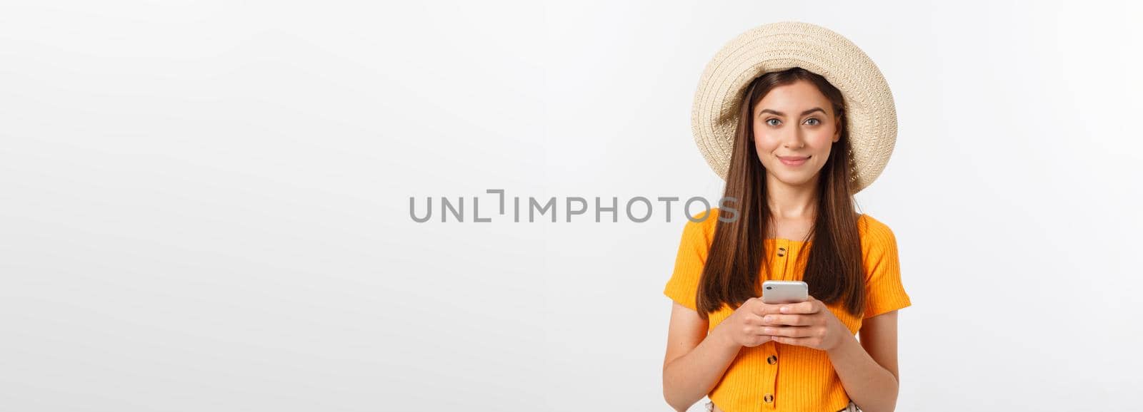 Happy young caucasian woman using smartphone standing isolated on white