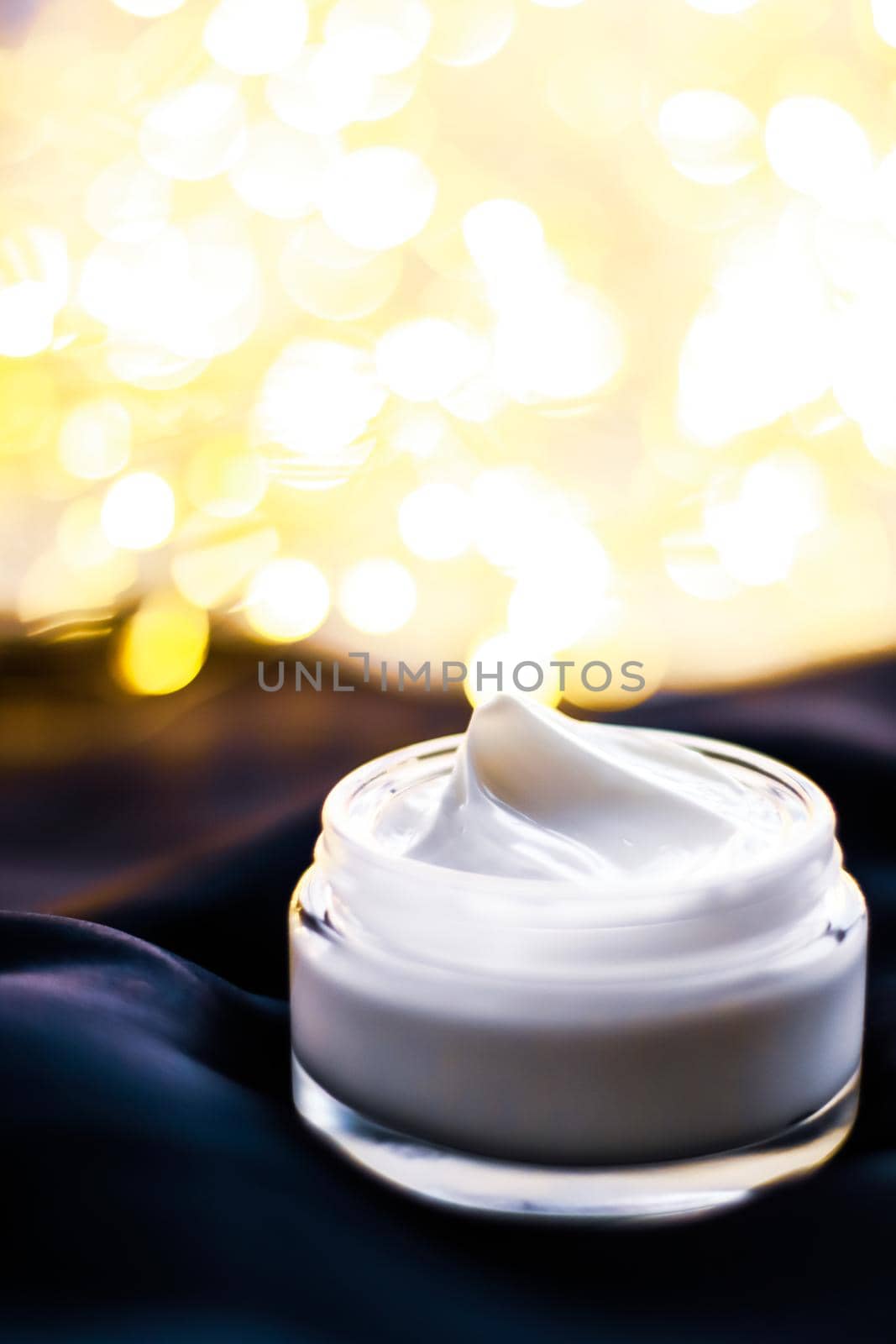 Beauty, anti-age cosmetics and skincare concept - Luxury face cream jar on a dark blue silk and holiday shine