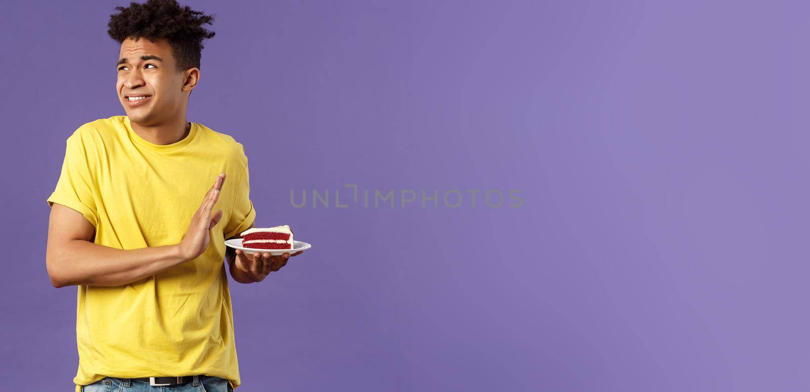 Celebration, party and holidays concept. Oh gosh its disgusting. Portrait of reluctant and displeased young man turn away from awful bad taste cake, show refusal, rejection or stop sign by Benzoix