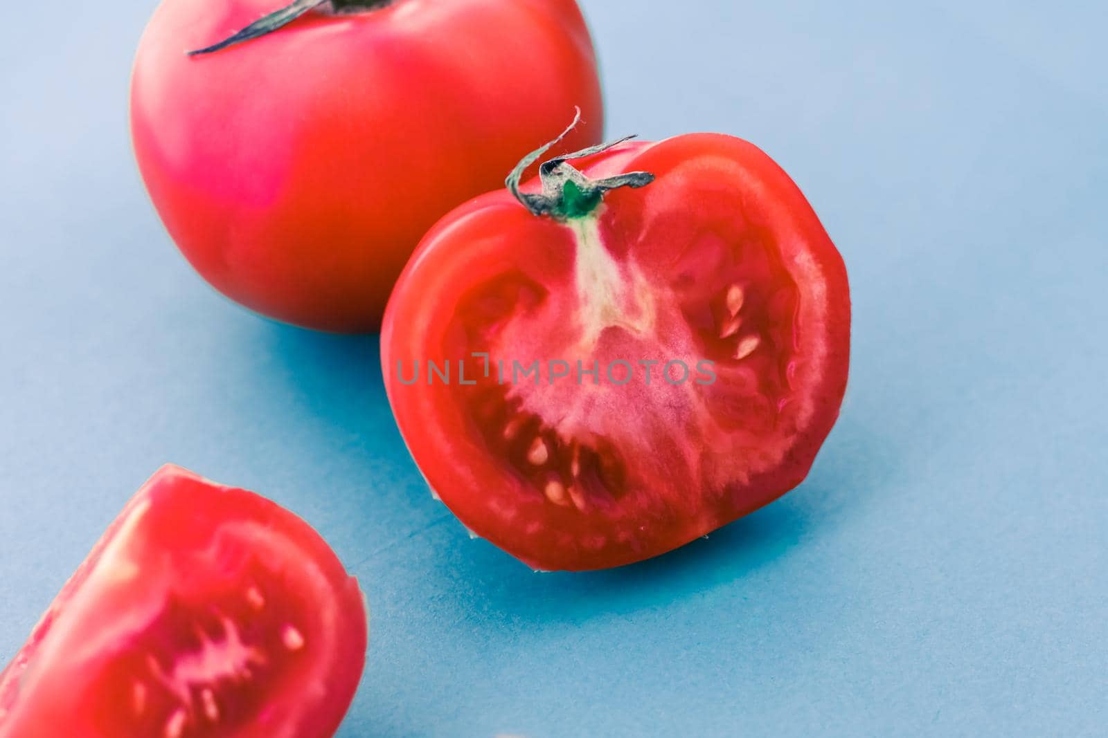 Plant based diet, vegetarian recipe and farm garden concept - Fresh ripe red tomatoes on blue background, organic vegetable food