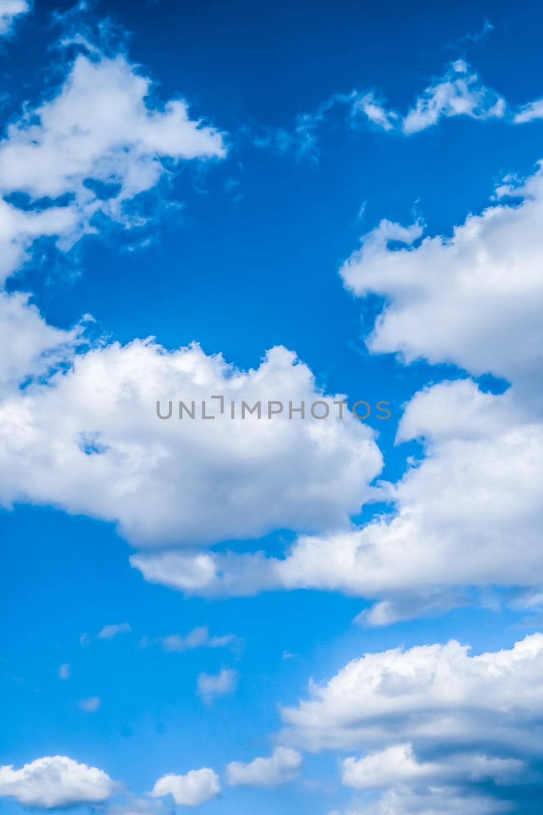 Nature backdrop, solar energy and spiritual concept - Blue sky background, white clouds and bright sunlight