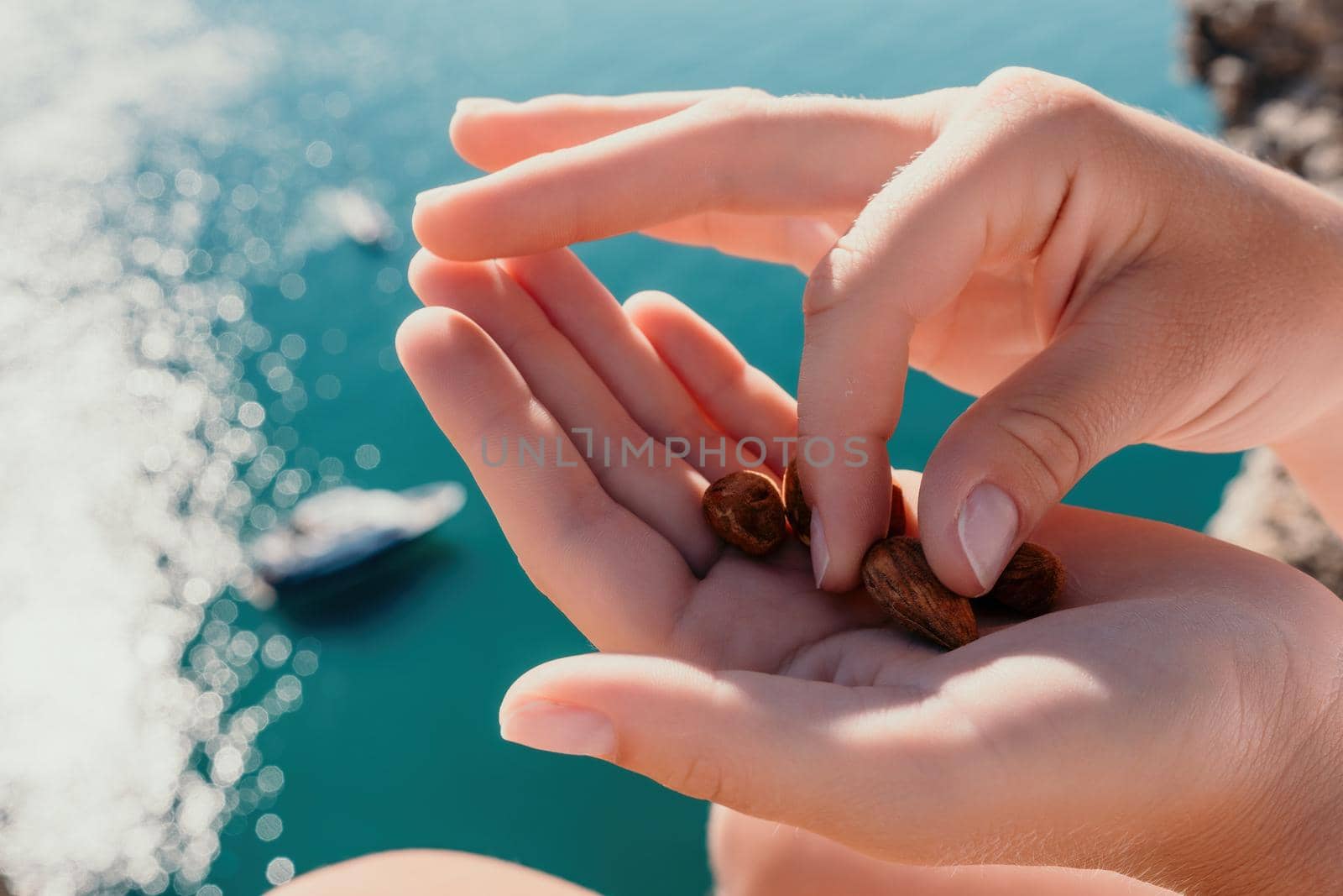 Unrecognizable caucasian woman eating young milky almond nuts. Healthy vegan food
