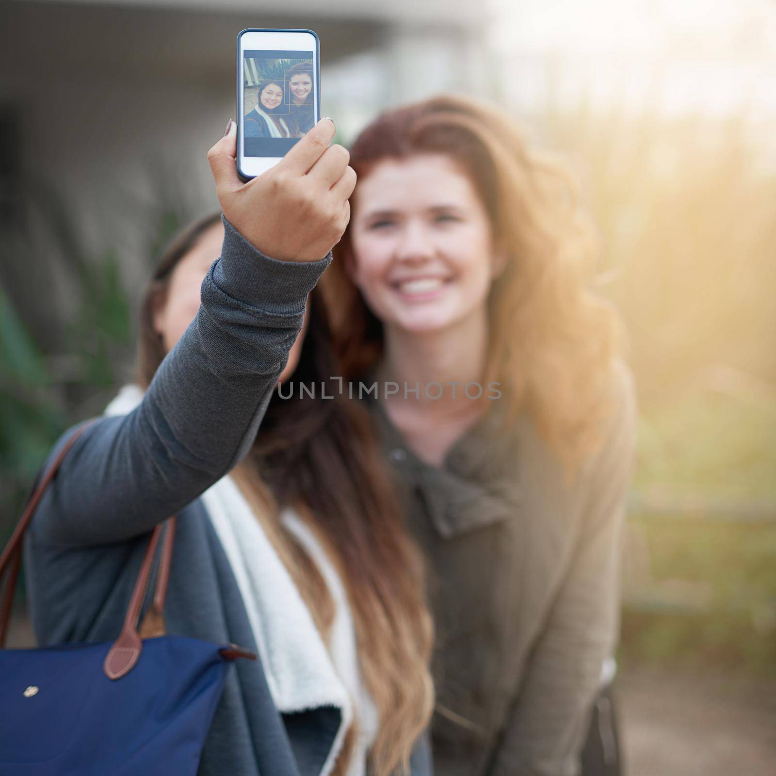 But first, let me take a selfie. two young women taking a selfie outdoors