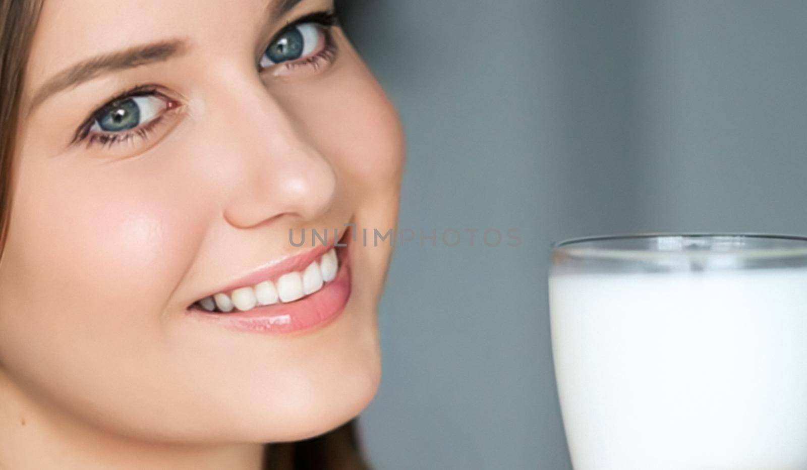 Diet and wellness, young woman with glass of milk or protein shake cocktail, portrait