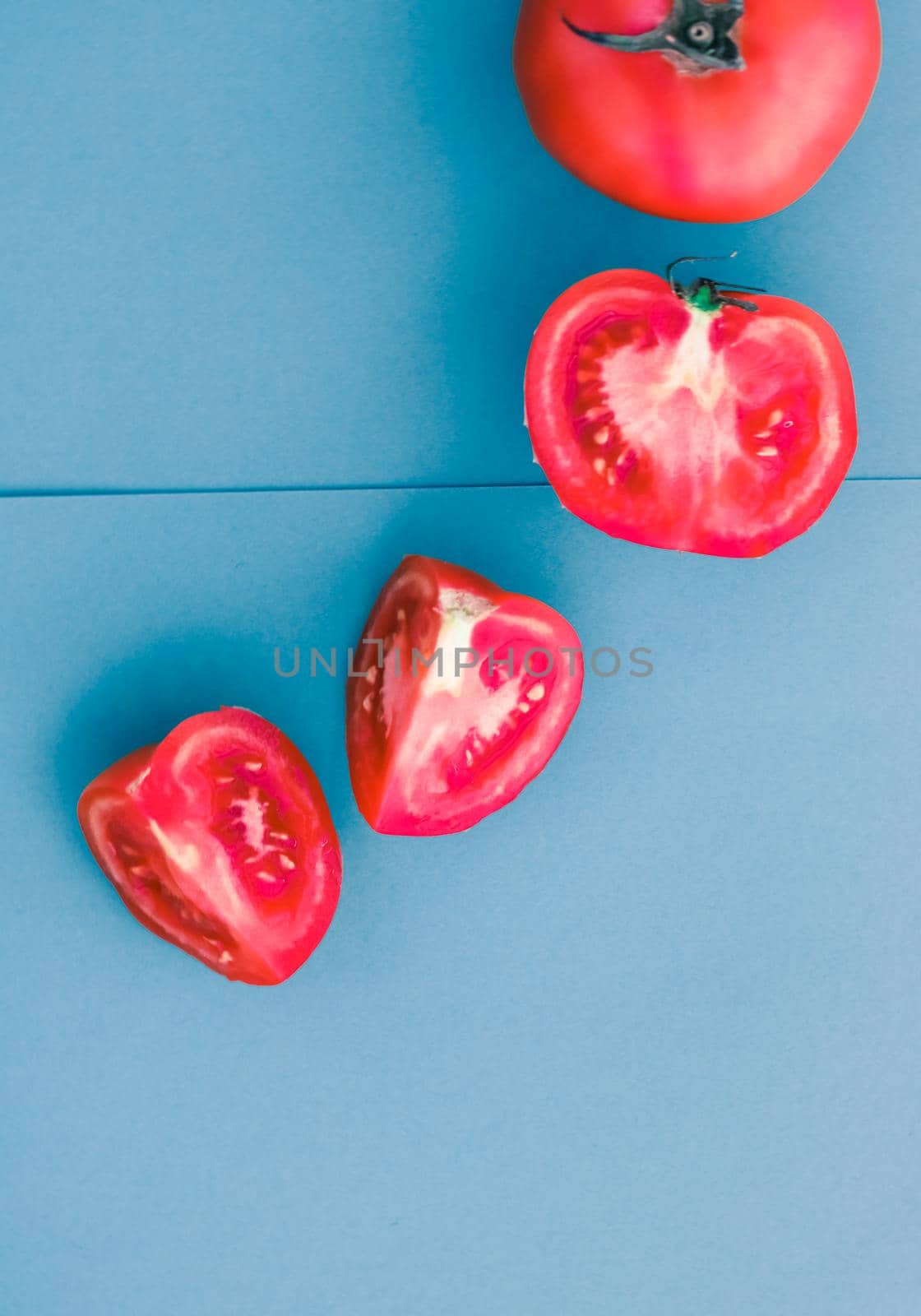 Plant based diet, vegetarian recipe and farm garden concept - Fresh ripe red tomatoes on blue background, organic vegetable food