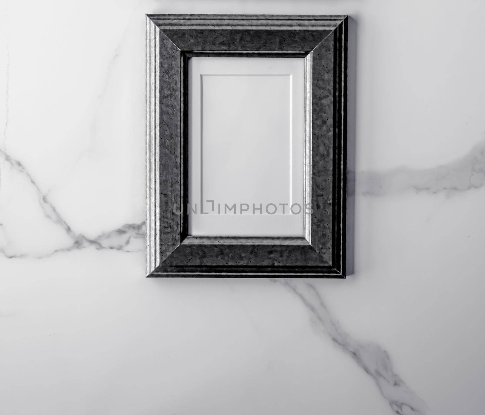 Black photo frame on marble, flatlay by Anneleven