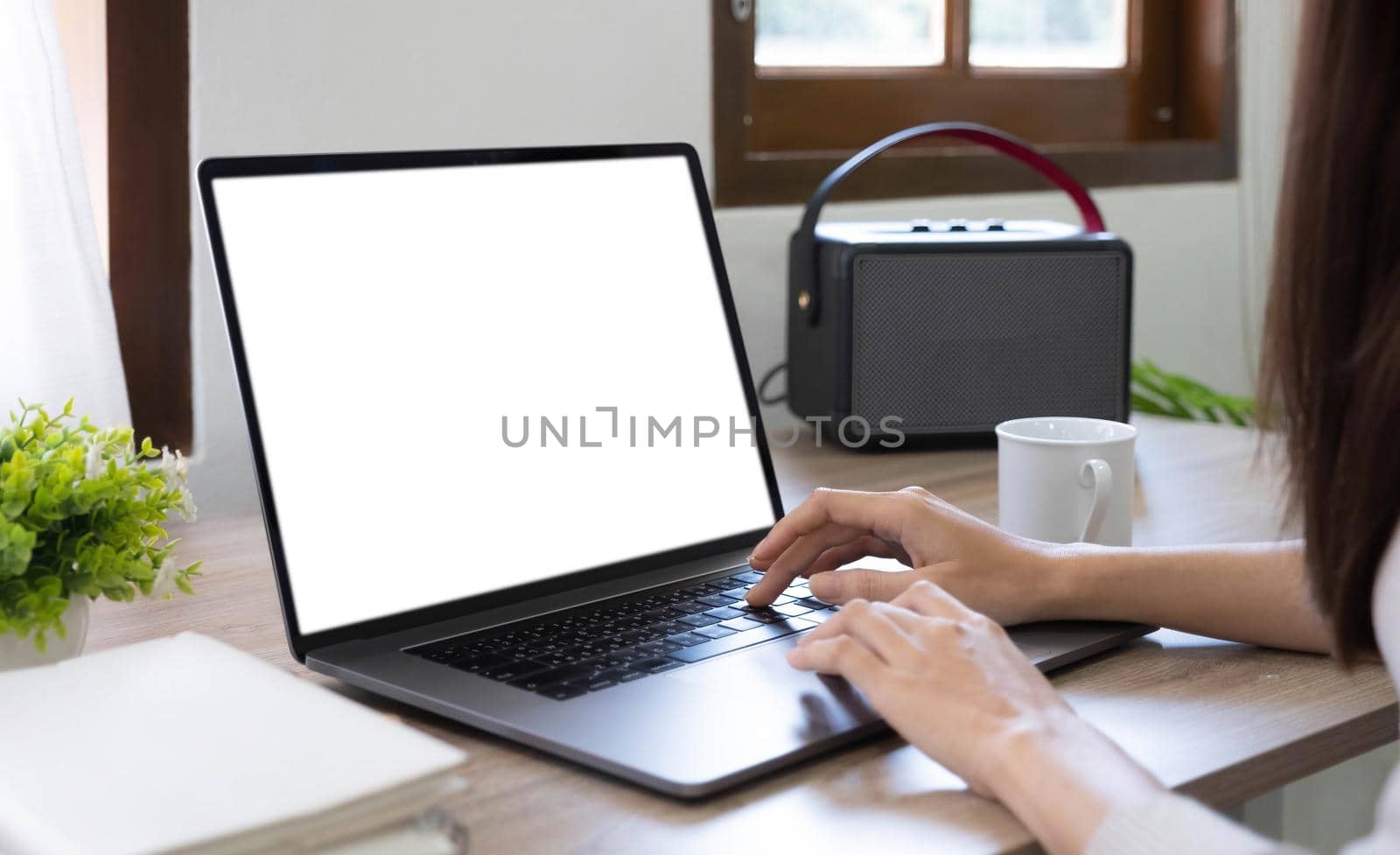 computer screen blank mockup.hand woman work using laptop with white background for advertising,contact business search information on desk at coffee shop.marketing and creative design by wichayada