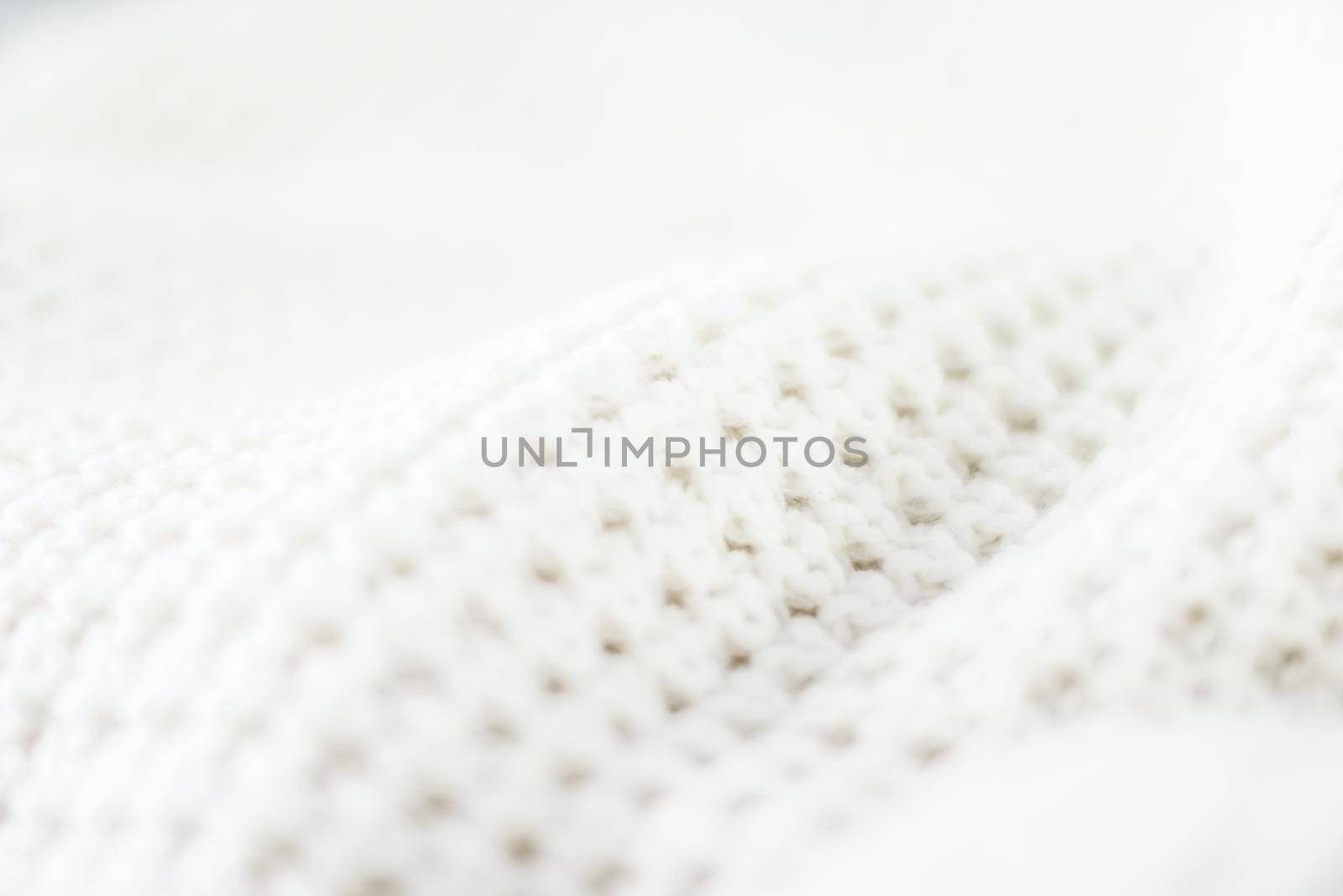 Knitwear, fabric textures and handmade items concept - Warm knitted clothes, soft and white