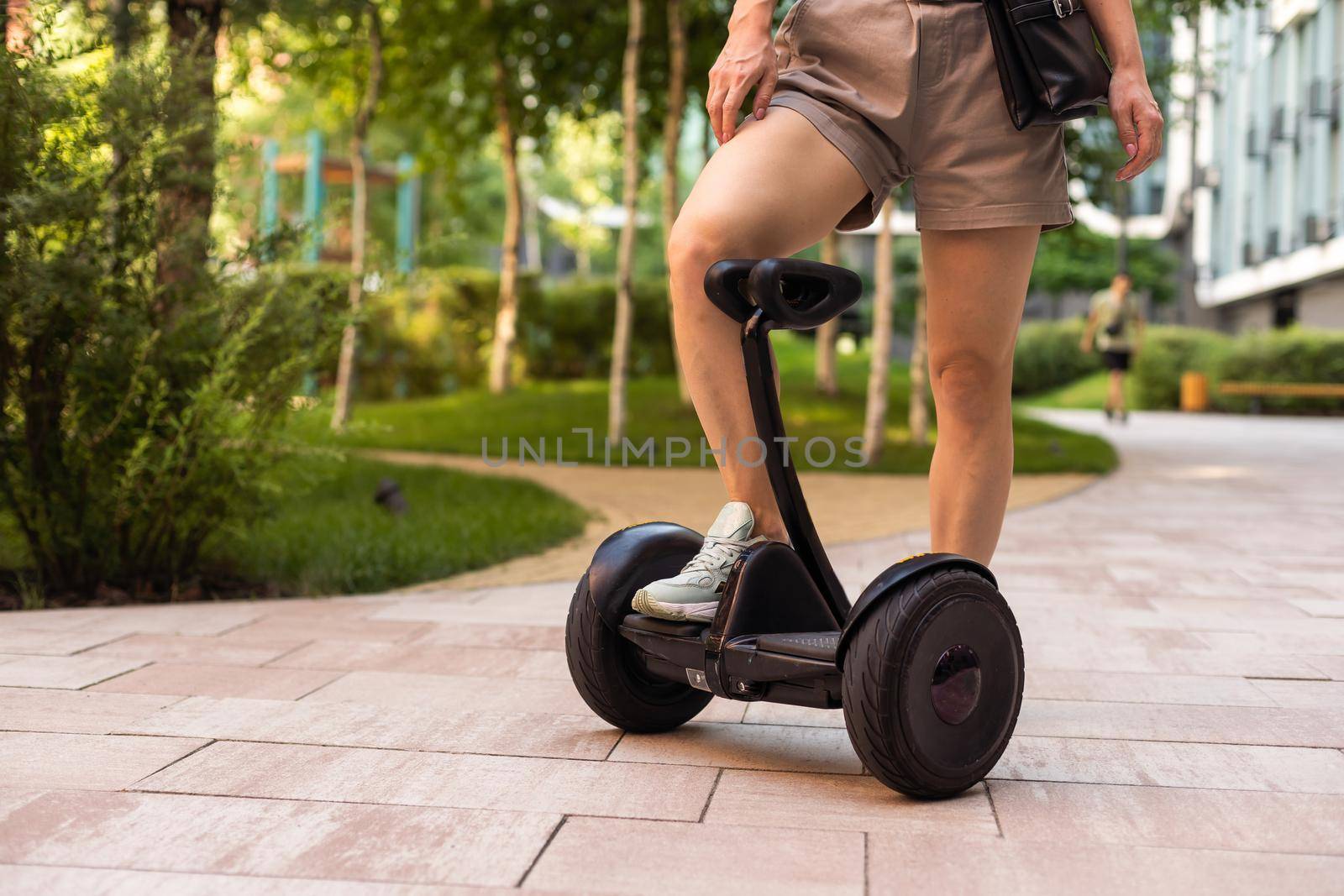 Beautiful woman stand near segway or hoverboard. self balancing electrical scooter