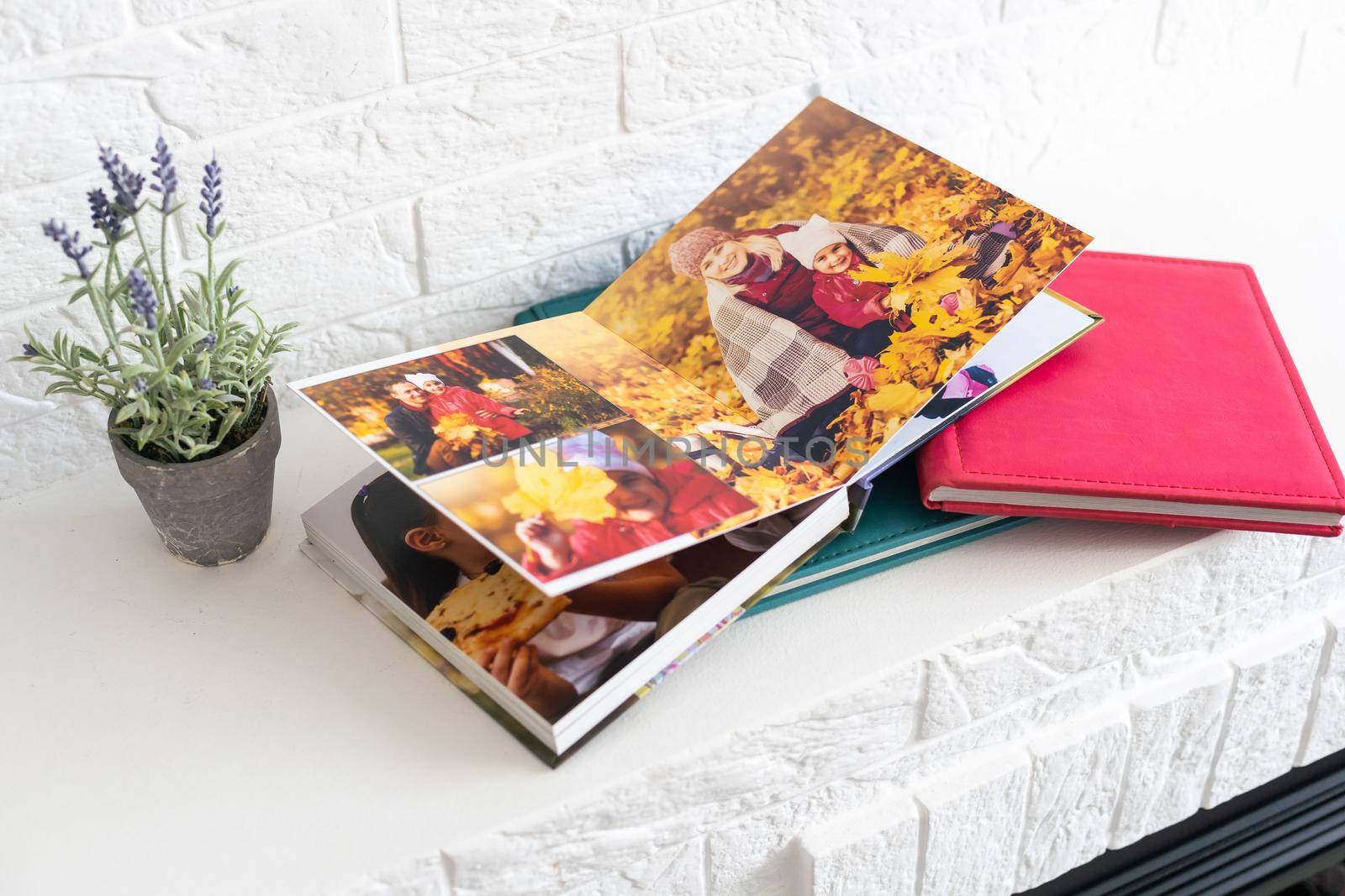 photo book with leather cover. Stylish photo album. Family photoalbum on the white table. Beautiful notepad or photobook with elegant openwork embossing on a white background