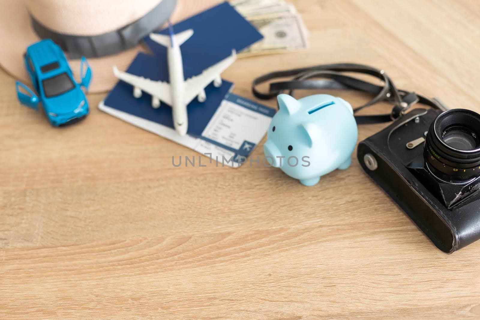 Travel concept. Airplane model, camera and passport on the table