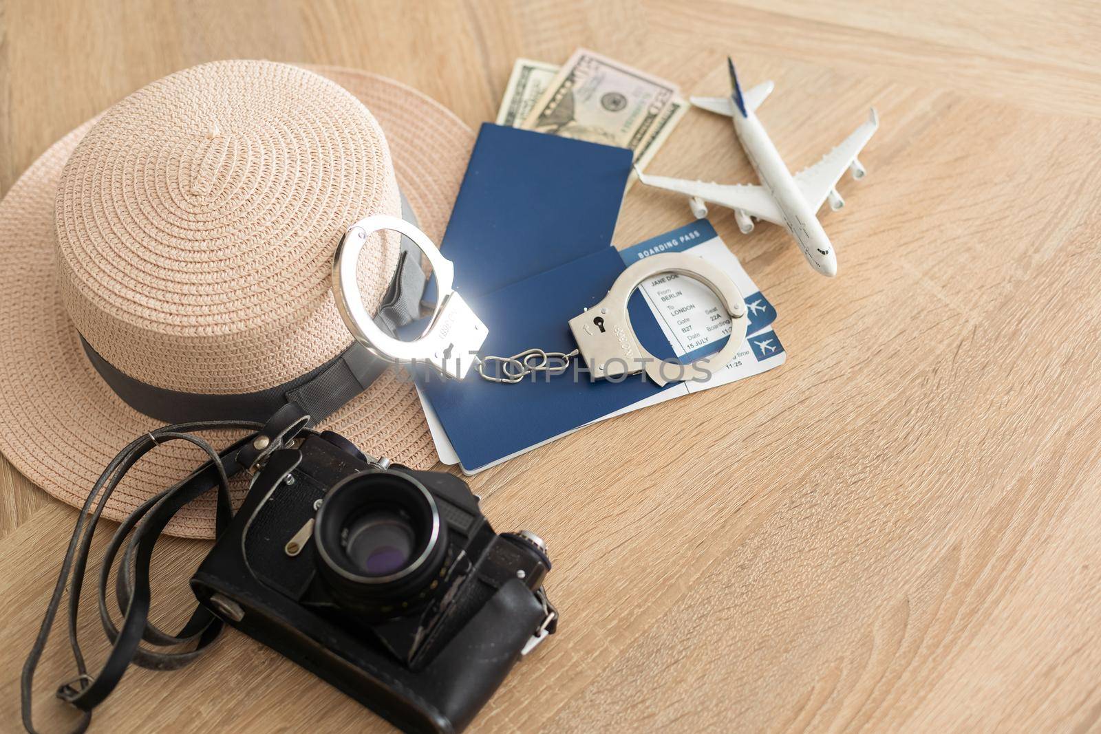 passport, tickets, toy plane, handcuffs