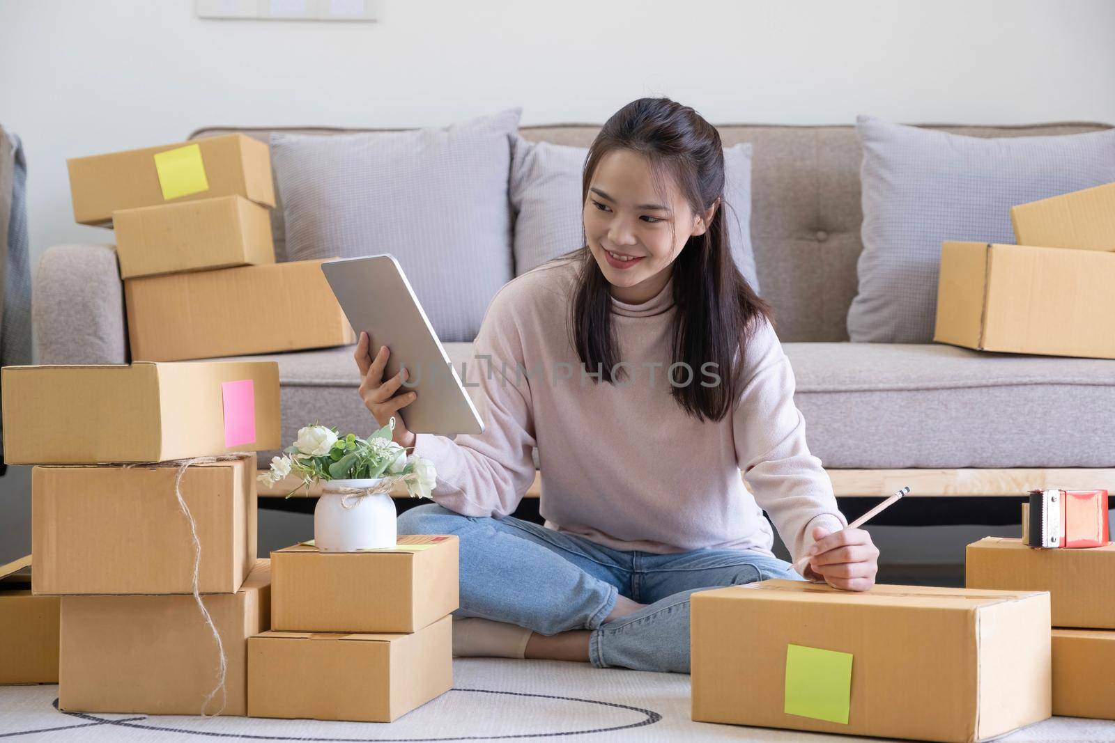 Starting small businesses SME owners female entrepreneurs check online orders to prepare to pack the boxes, sell to customers, sme business ideas online..