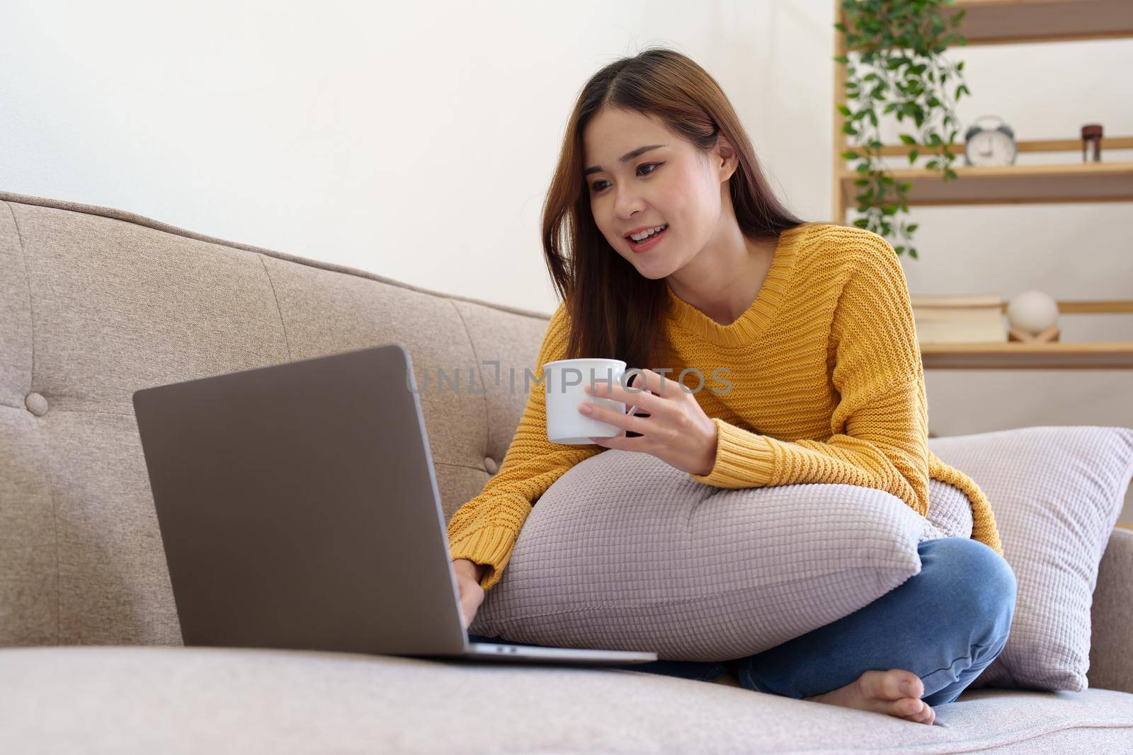 Portrait of an Asian businesswoman or business owner taking a coffee break while working in the office.