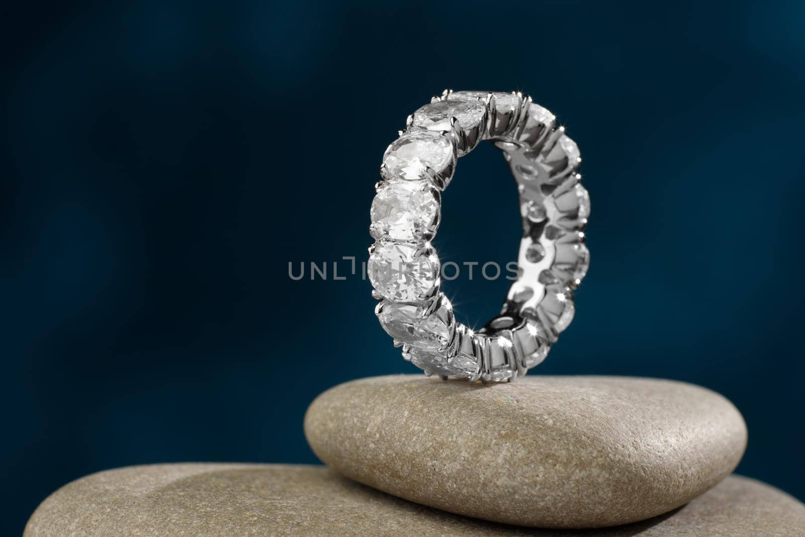White gold ring band on river stones