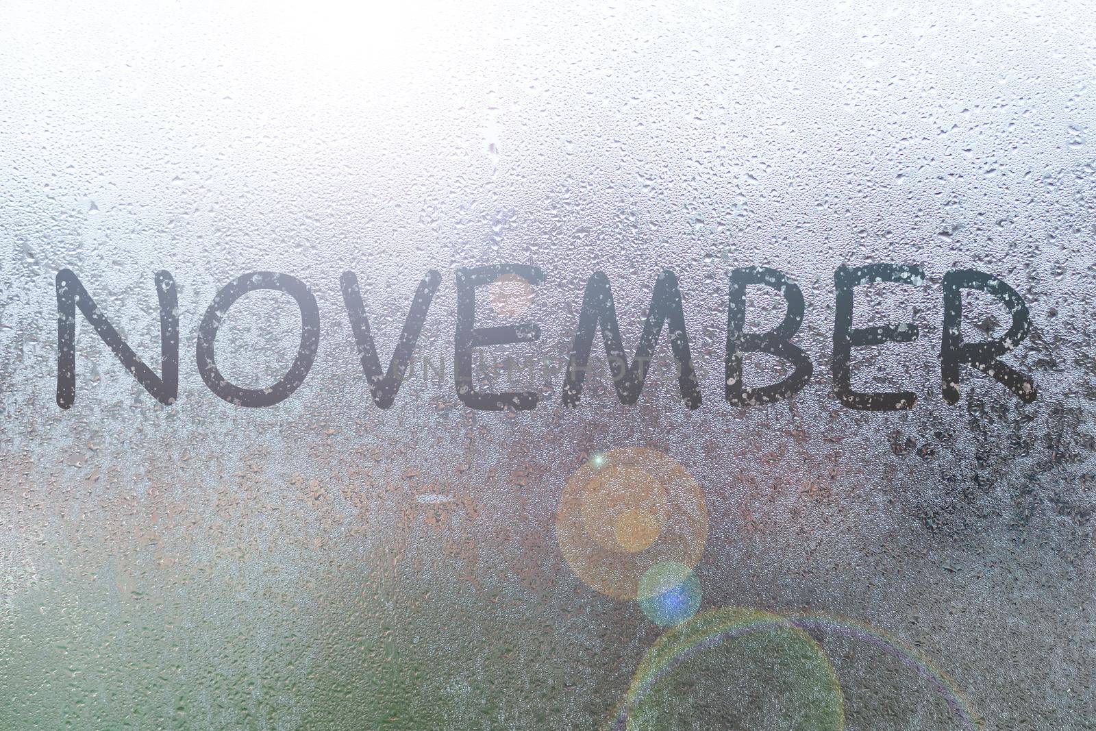Autumn rain, the inscription on the sweaty glass - November.