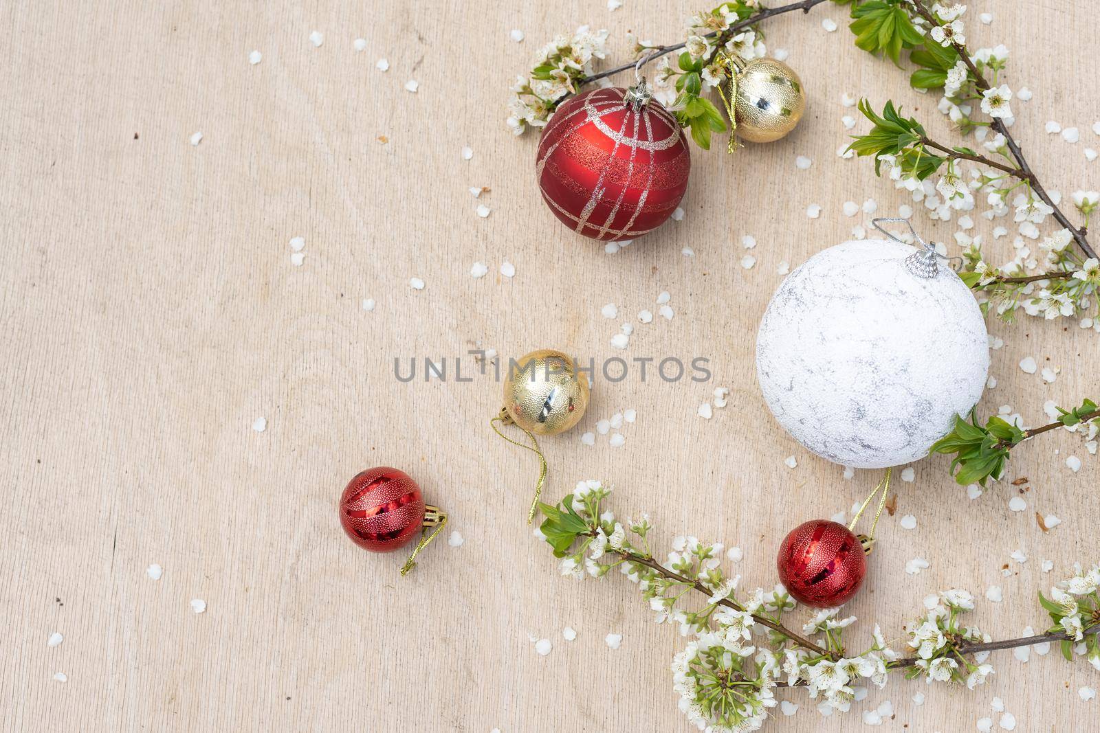 Christmas decorations and a branch with a flower.