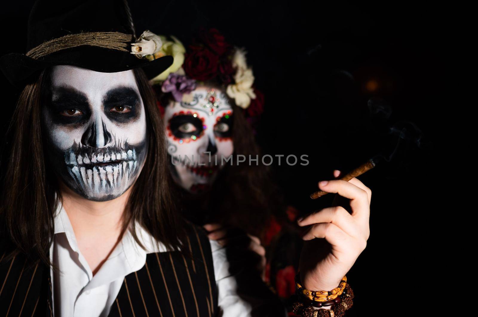 Man and woman in paired halloween costumes. Body art santa muerte and skeleton by mrwed54